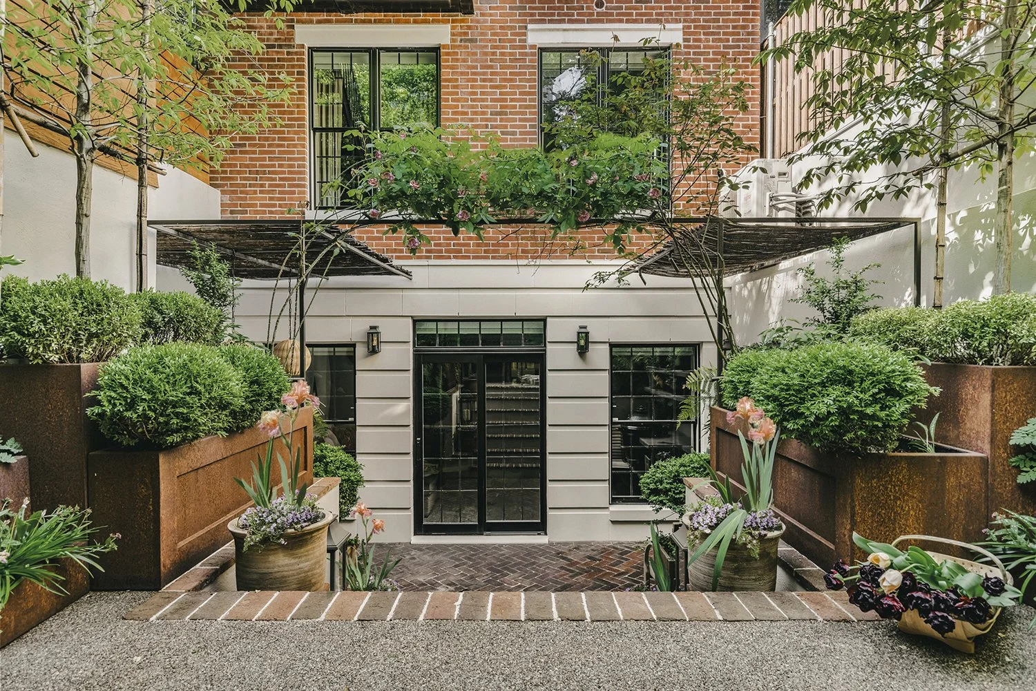 Lower terrace framed by Corten steel planters and pleached trees, Townhouse Garden, Brooklyn