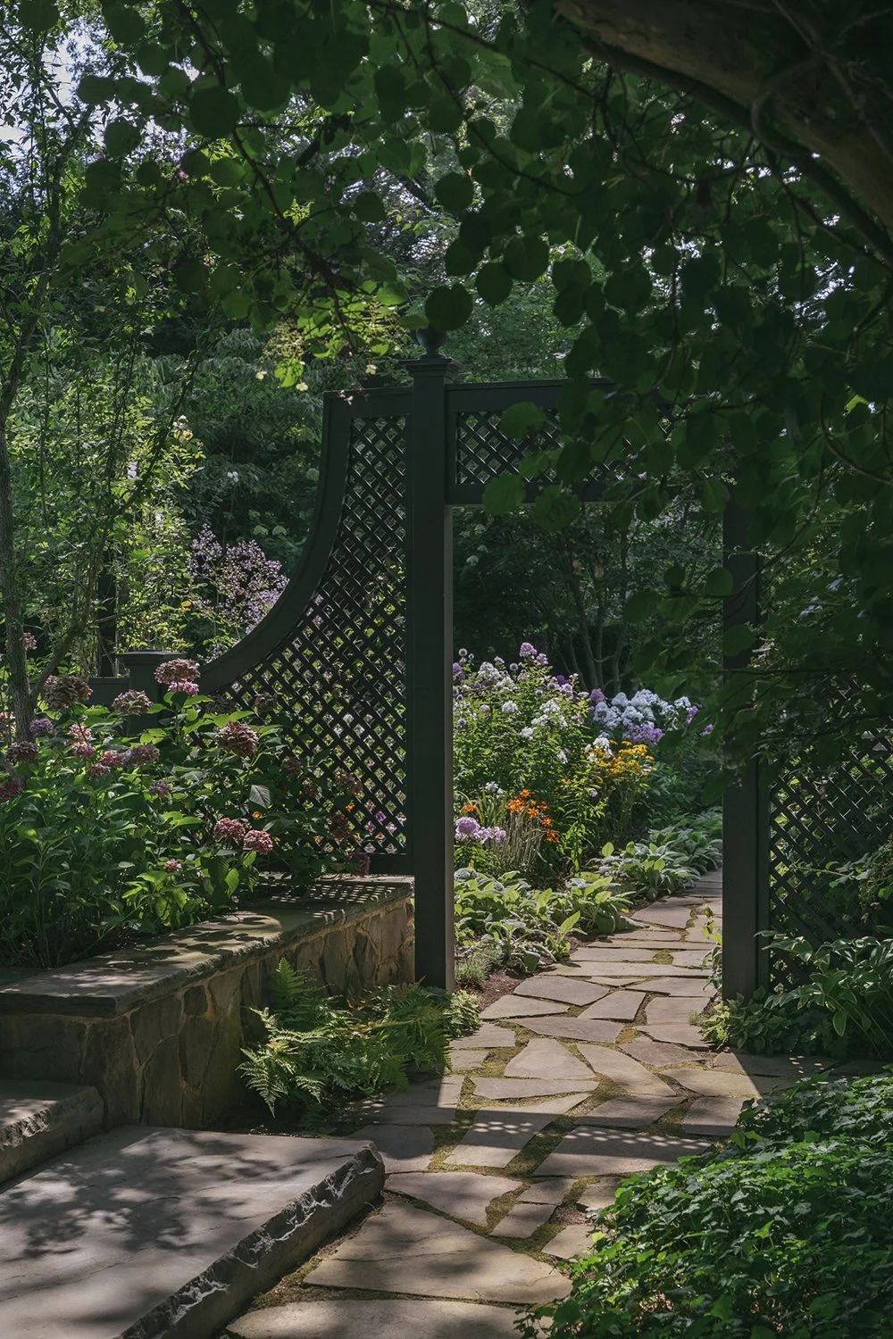 Stone path through a trellis archway into the next garden room, Historic Garden, Shrewsbury NJ