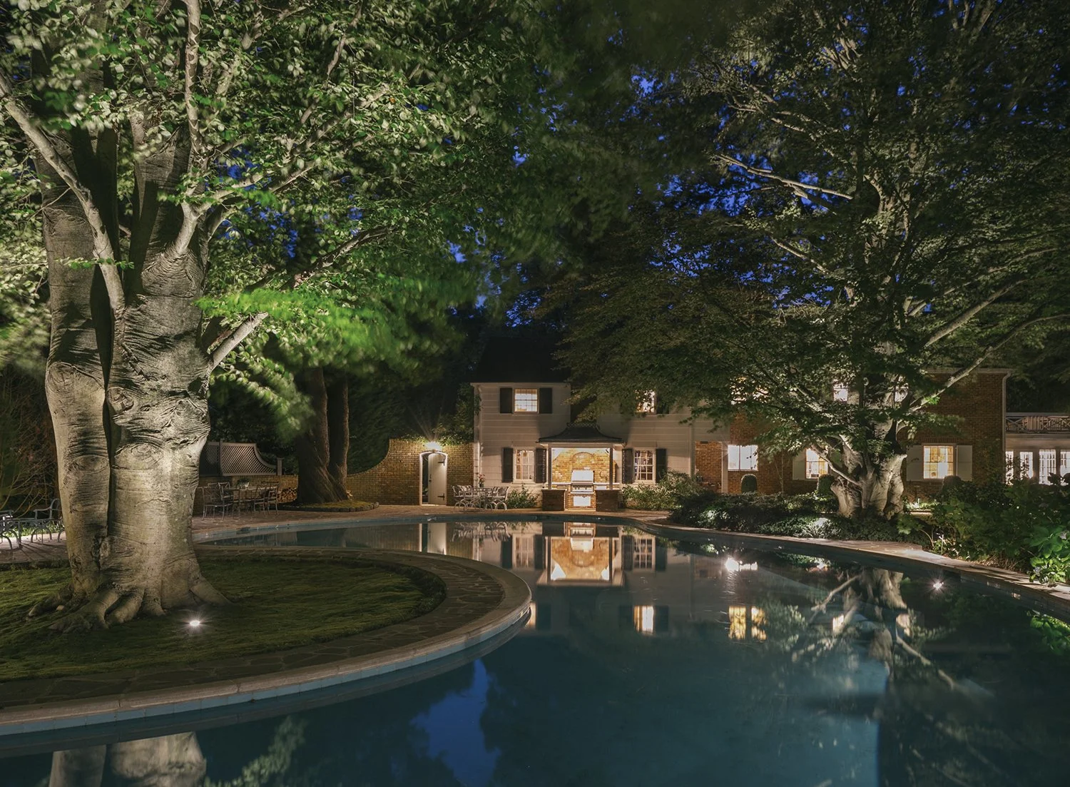 Serpentine pool and mature beech tree lit at night, Historic Garden, Shrewsbury NJ