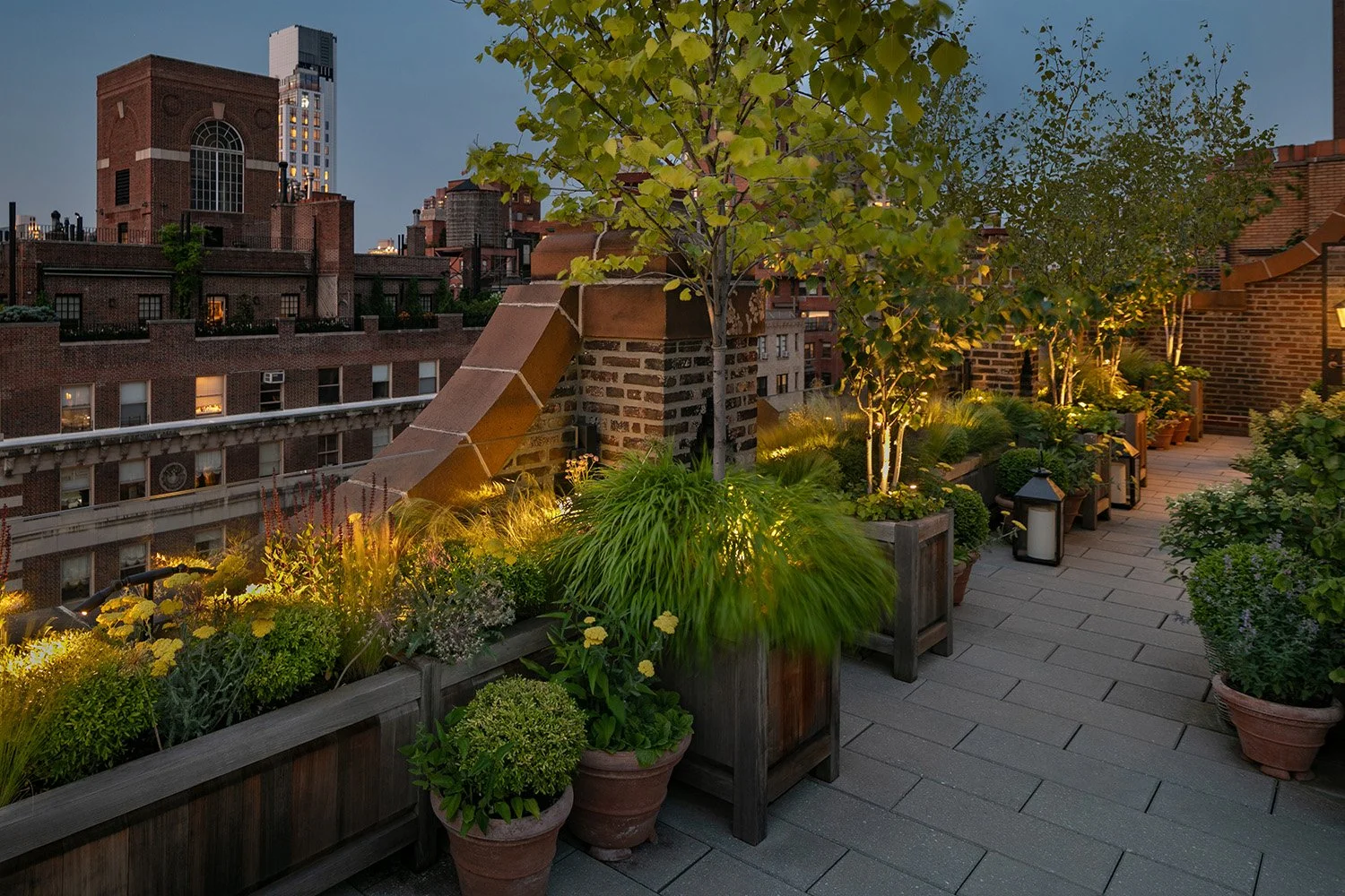Terrace planting softly lit at dusk among the surrounding rooftops, Upper East Side Penthouse