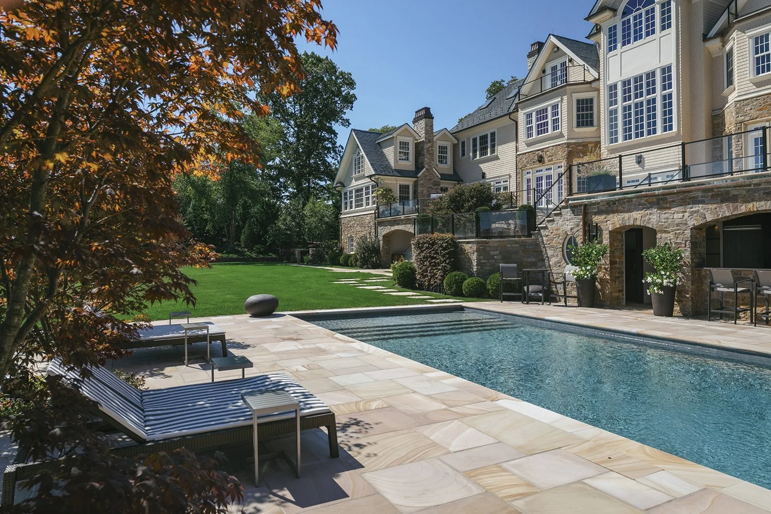 Pool terrace below the house framed by red Japanese maples, Riverfront Estate, Navesink River