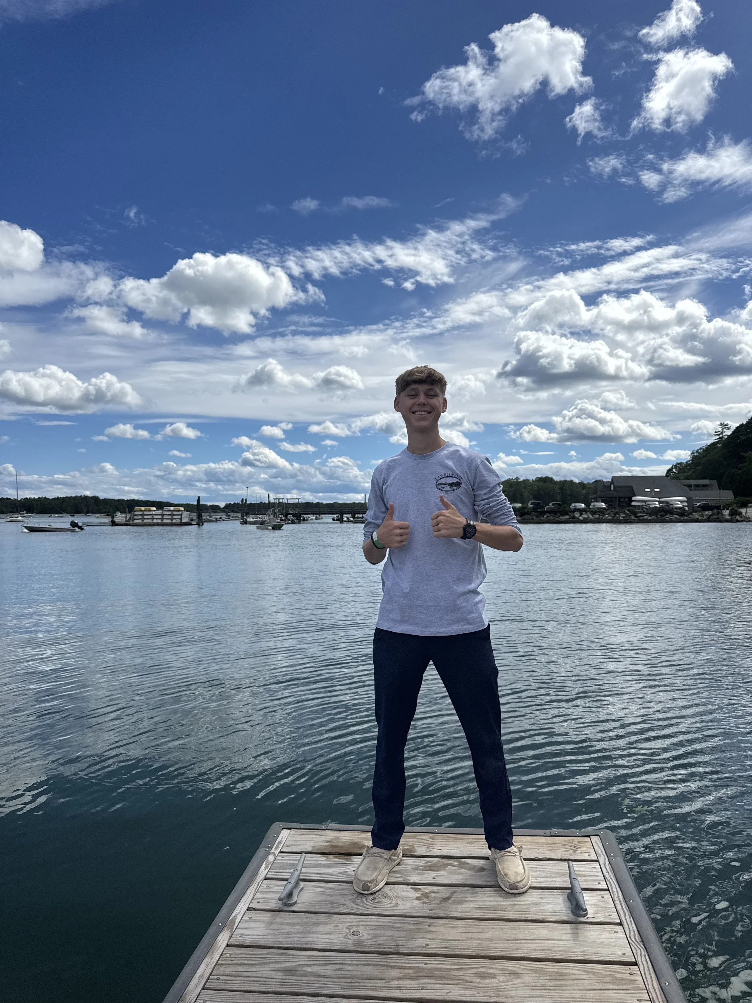 Jonathan poses for a picture next to a beautiful lake in Maine.