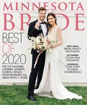 Cover of Minnesota Bride magazine featuring a smiling bride and groom in wedding attire holding a bouquet of flowers, standing on grass against a pink and white backdrop with magazine headlines.