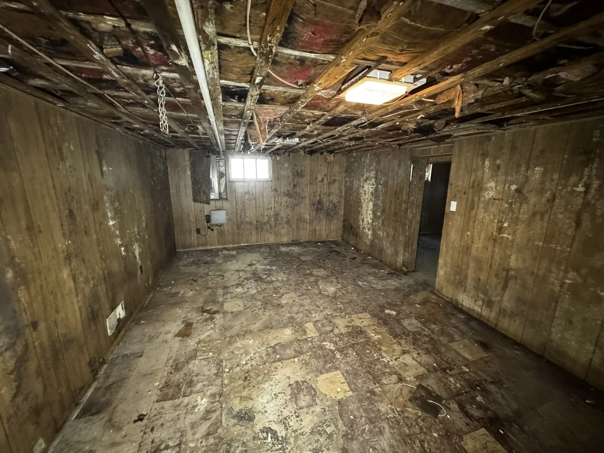 BEFORE — Basement before renovation at 14 Bradford Road.