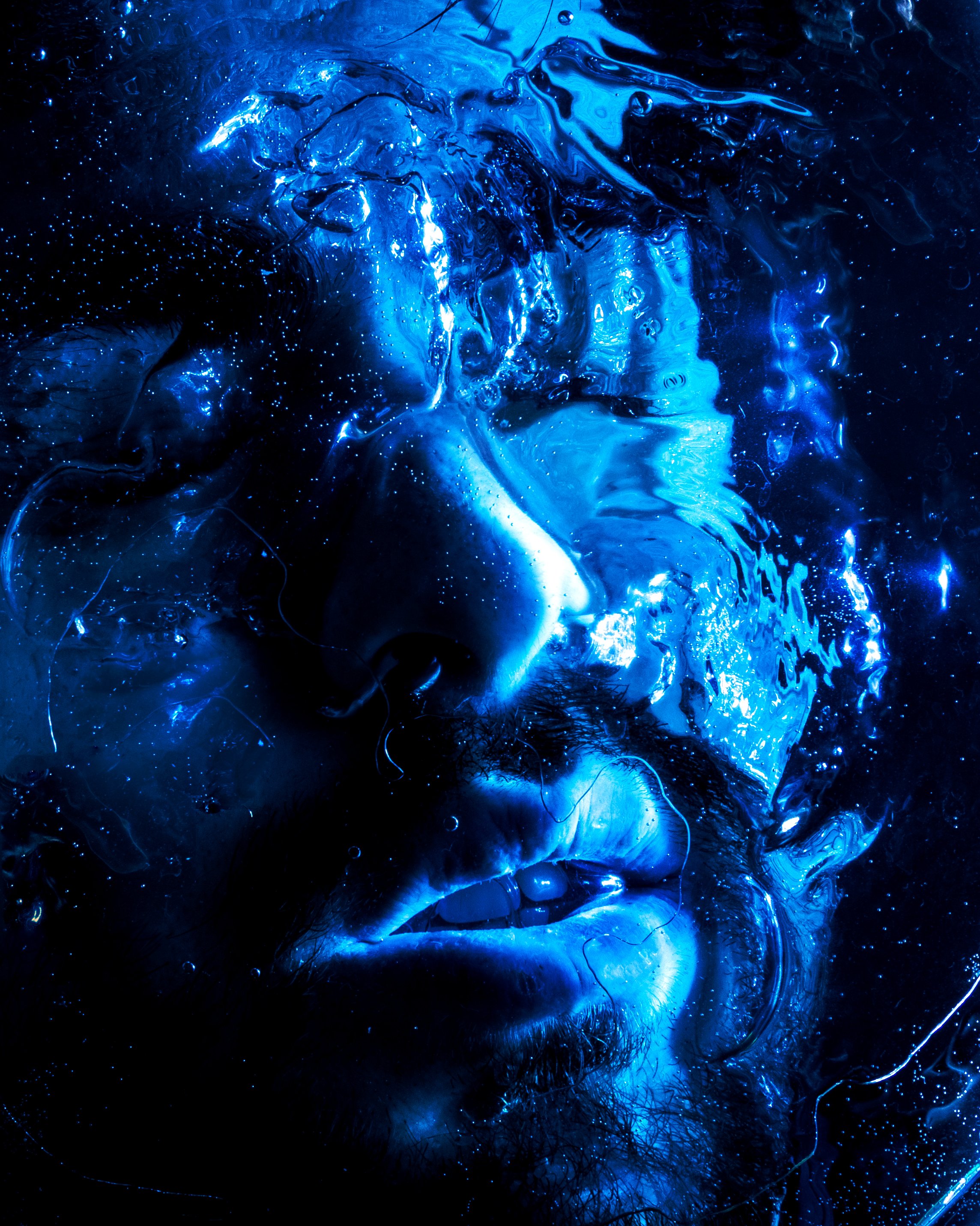 Abstract image with swirling blue and black colors, glowing orbs, and intricate patterns.