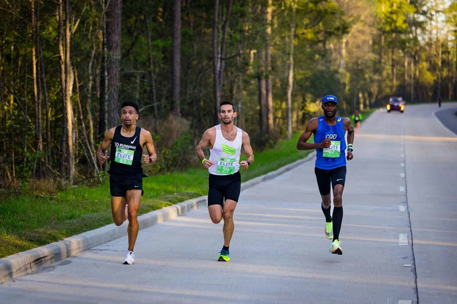 Three runners racing through The Woodlands