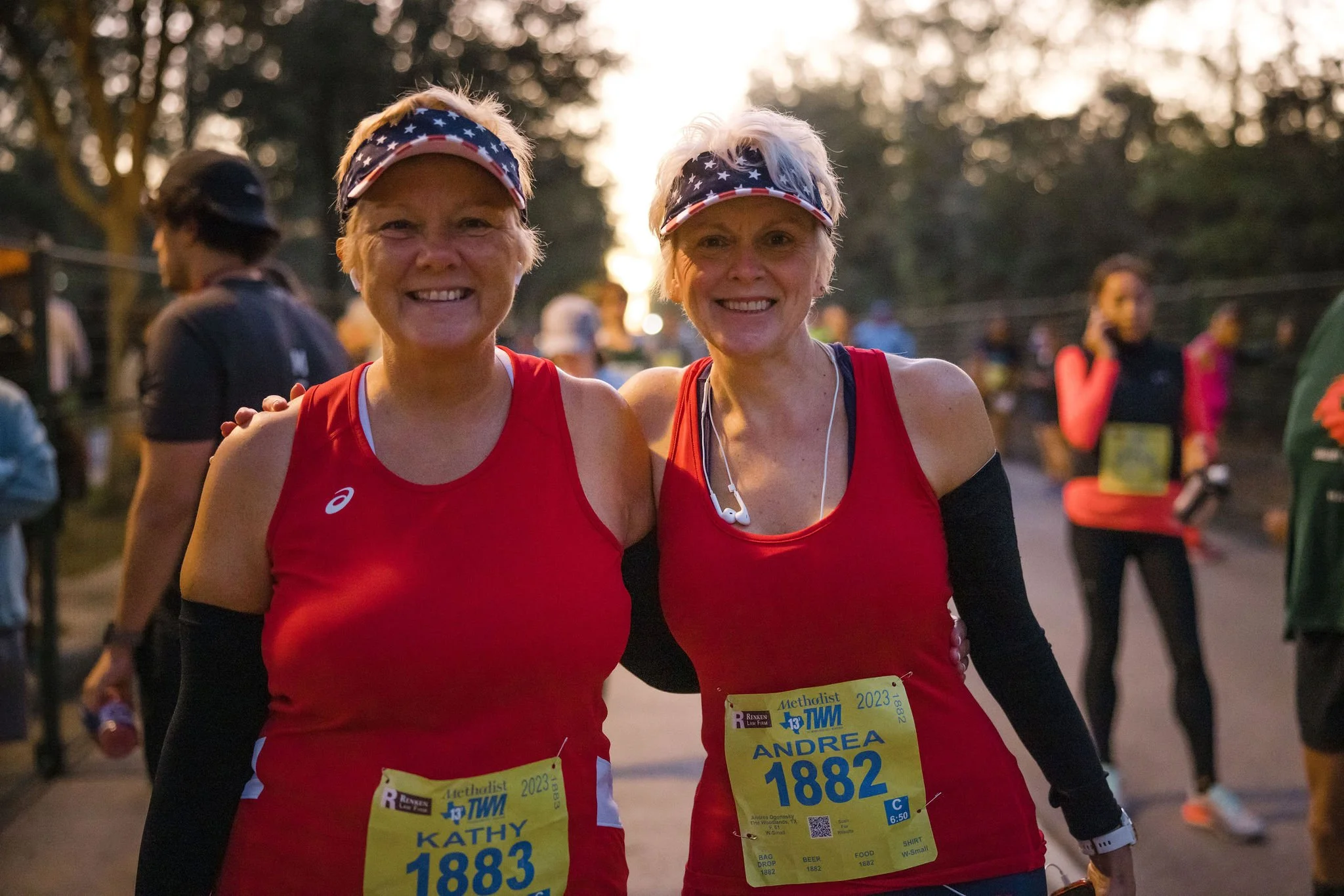 Two runners smiling together before The Woodlands Marathon