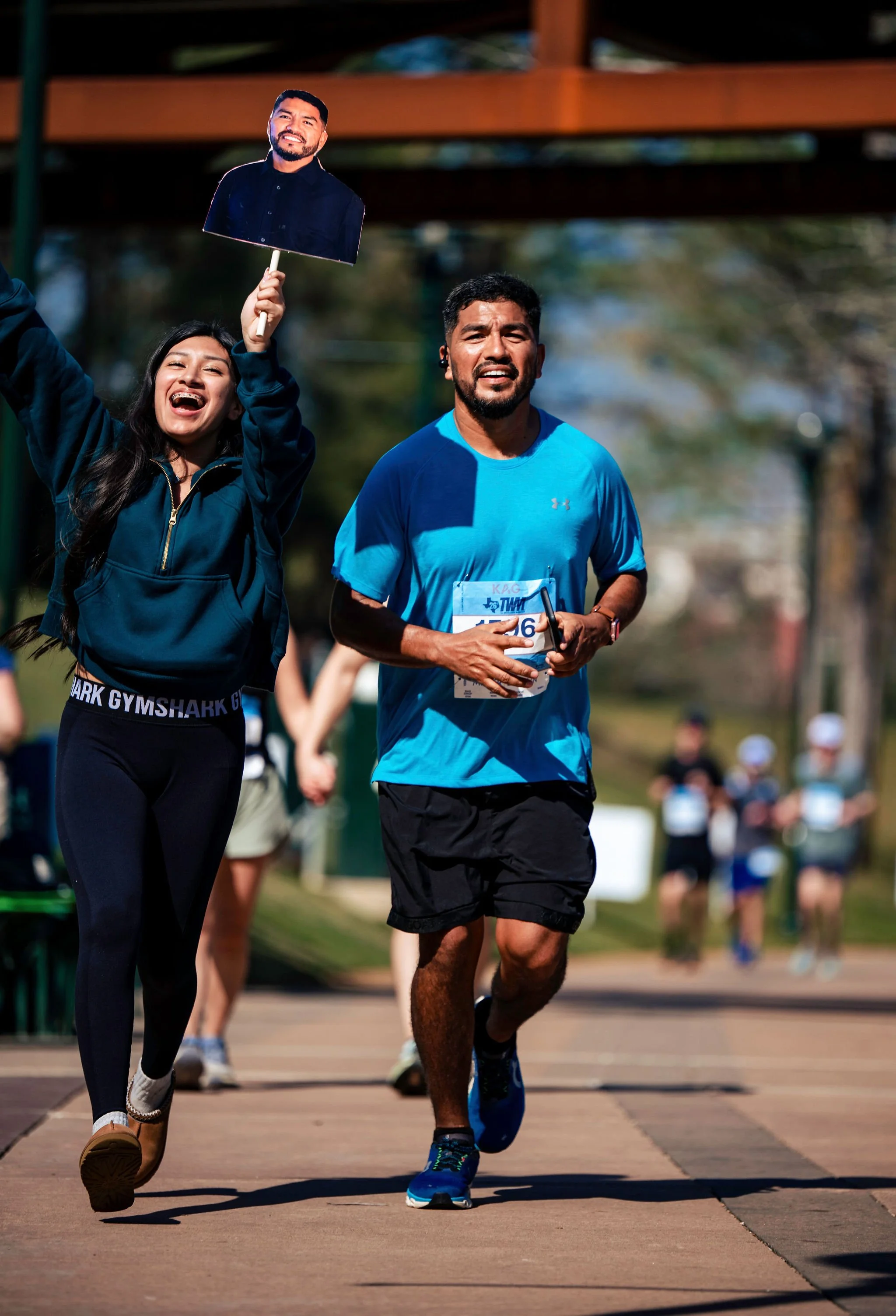 A runner and supporter celebrating together along the course