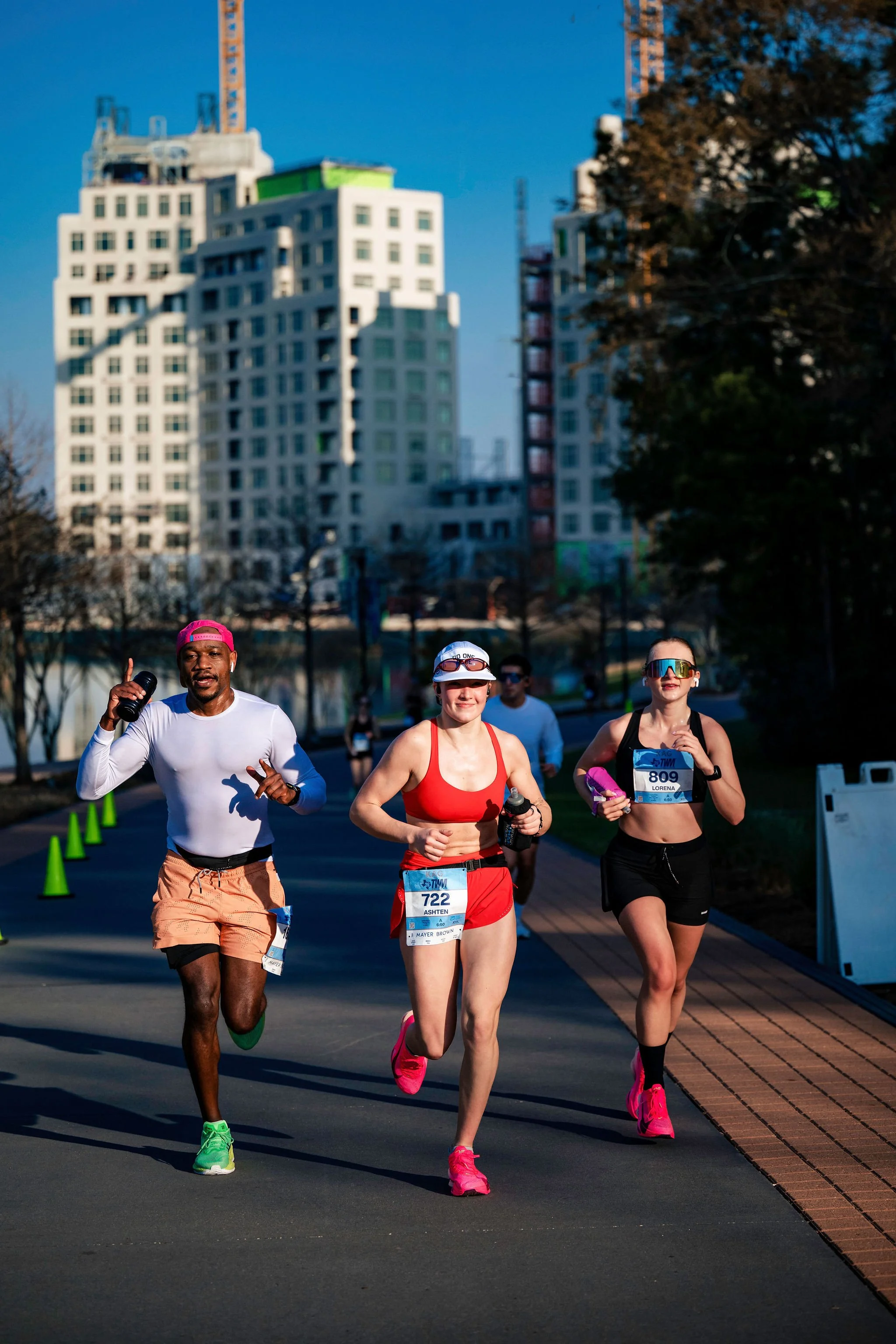 Women runners moving together beside The Woodlands Waterway