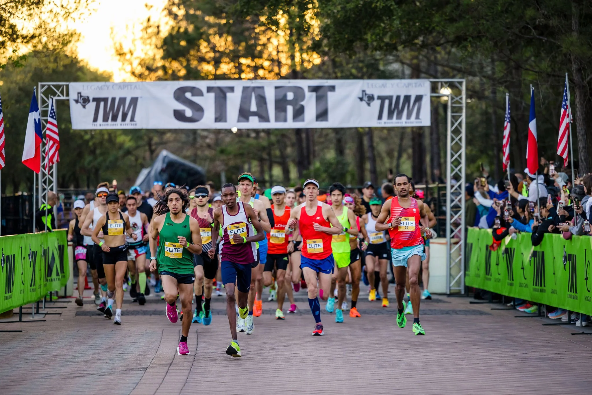 Runners crossing the start line at The Woodlands Marathon