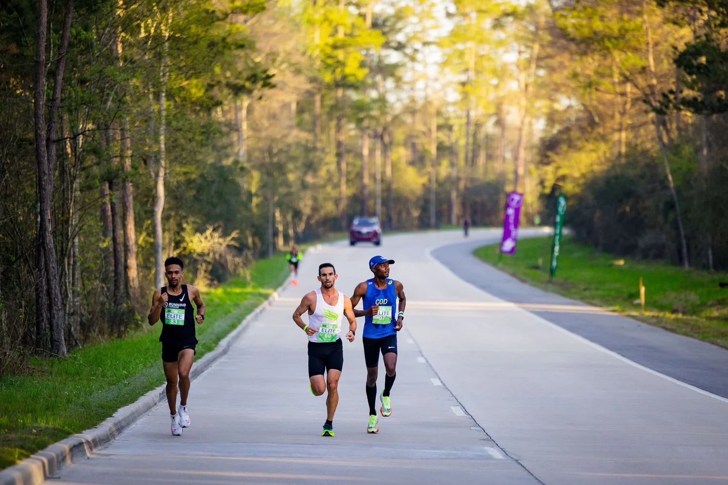 Runners moving together along The Woodlands Marathon course