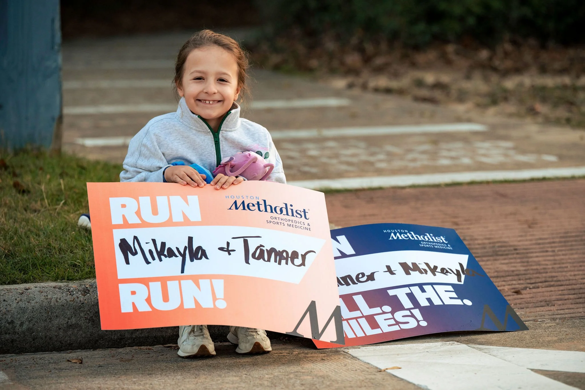 Young spectator holding handmade race signs