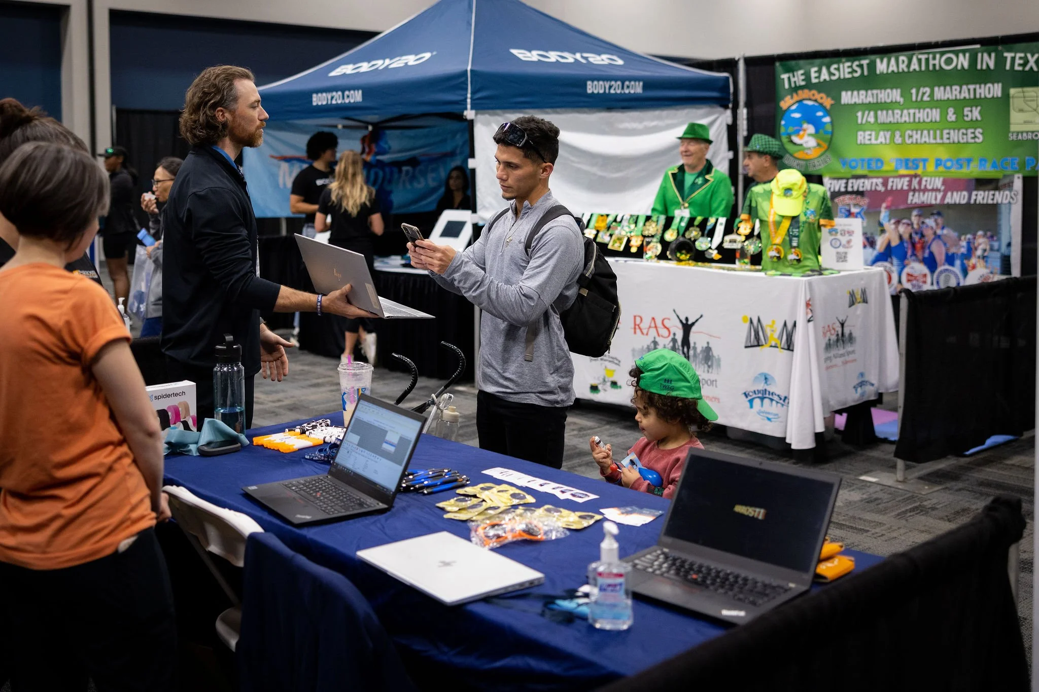 Runners and families visiting vendor booths at the Expo