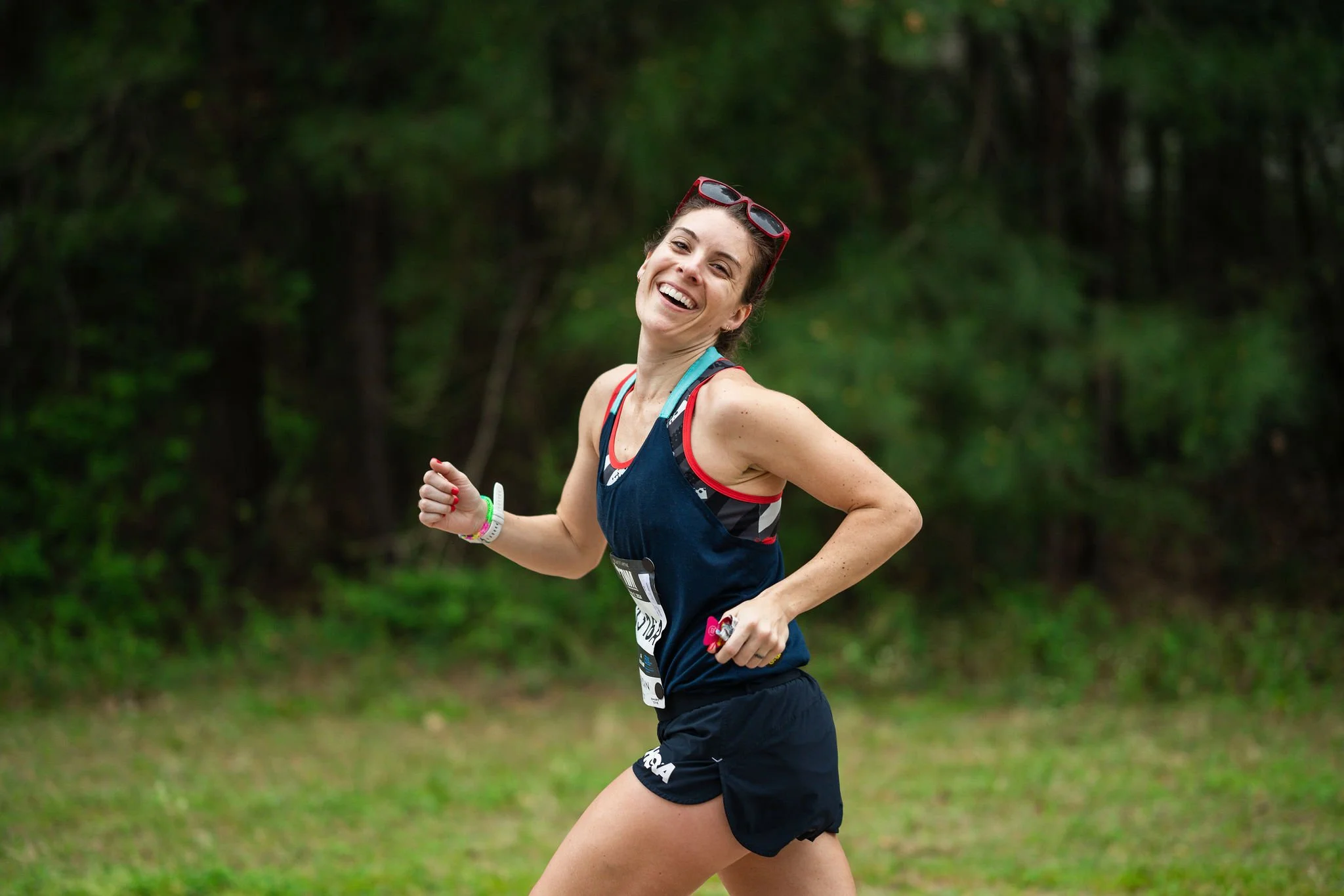 A Woodlands Marathon runner smiling on course