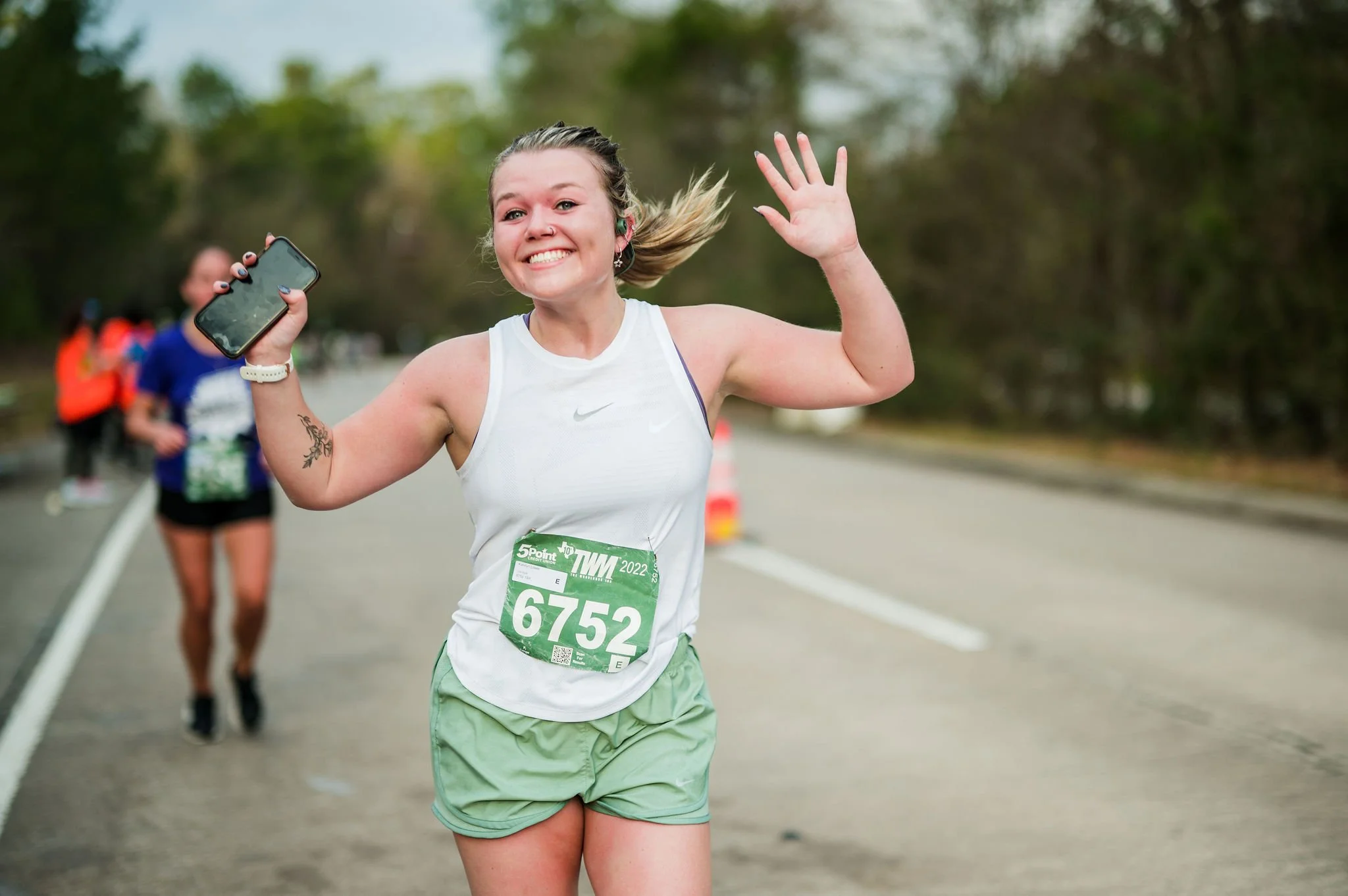 A Woodlands Marathon participant celebrating after the race
