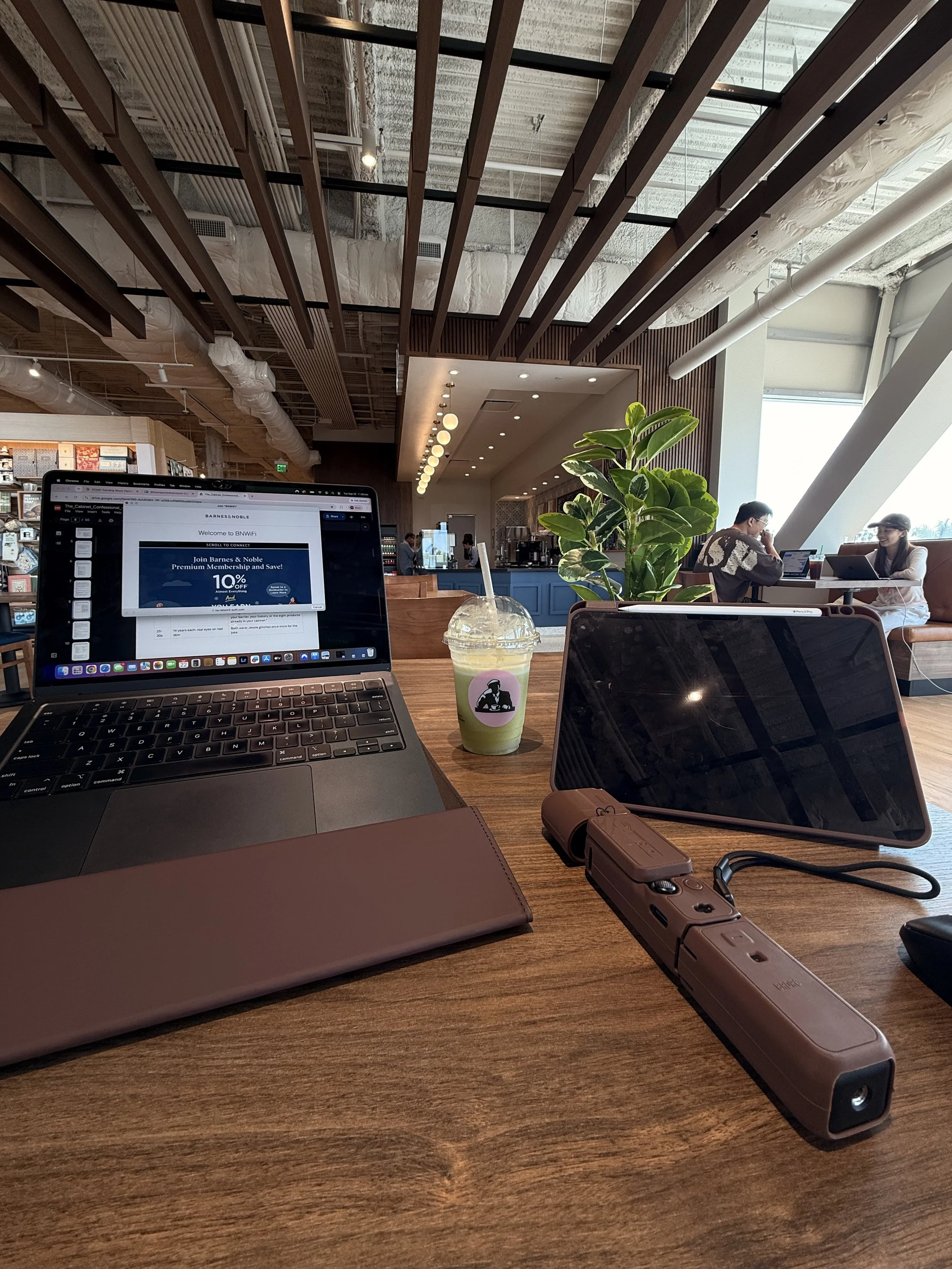 Laptop, tablet and coffee on a cafe table, set up for remote business systems consulting