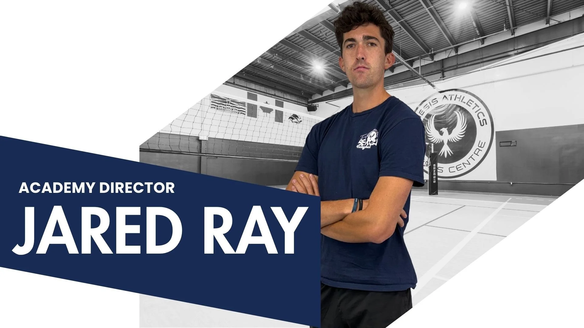 A man standing with arms crossed in a gymnasium with volleyball court markings and a volleyball net, behind him is a wall with a logo that reads 'SENIORS ATHLETICS CENTRE.' The man is wearing a navy blue t-shirt with a small logo on the left side. The image has a graphic overlay with text saying 'ACADEMY DIRECTOR JARED RAY.' The background is mostly black and white, with the overlay text in white on a dark blue background.