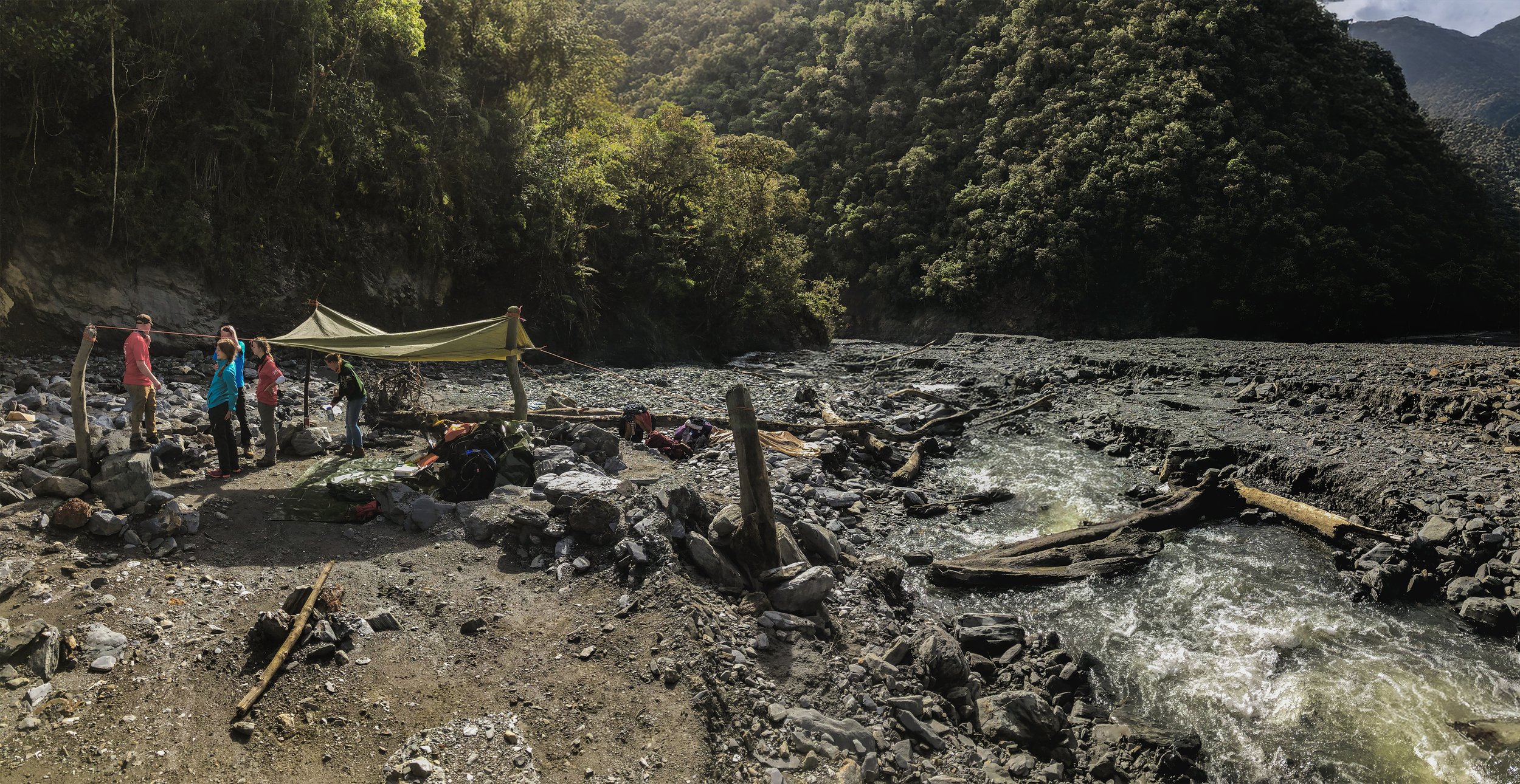 On location beside a rocky river in the jungle