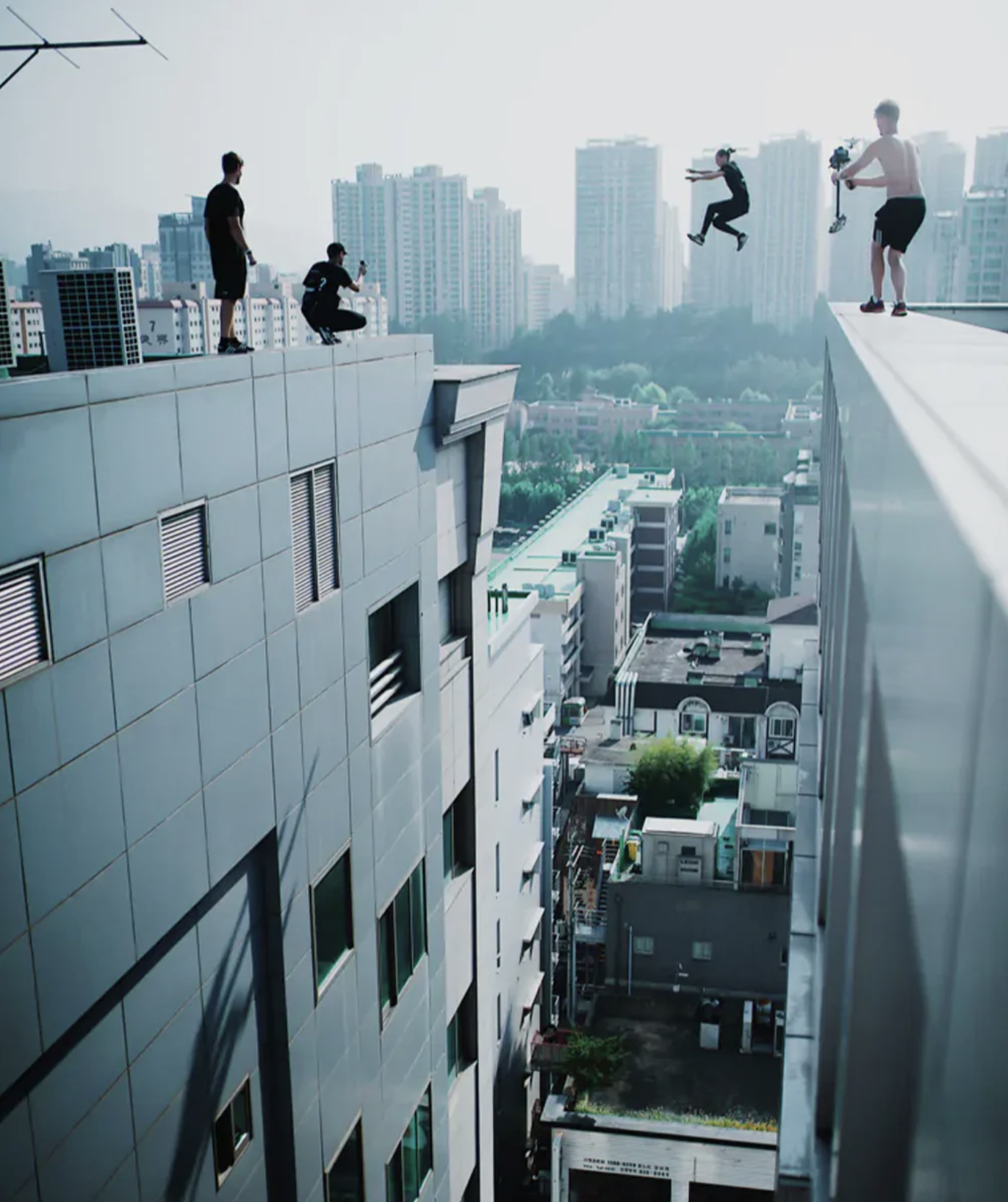 Storror athletes and camera crew filming a rooftop jump for Roof Culture Asia