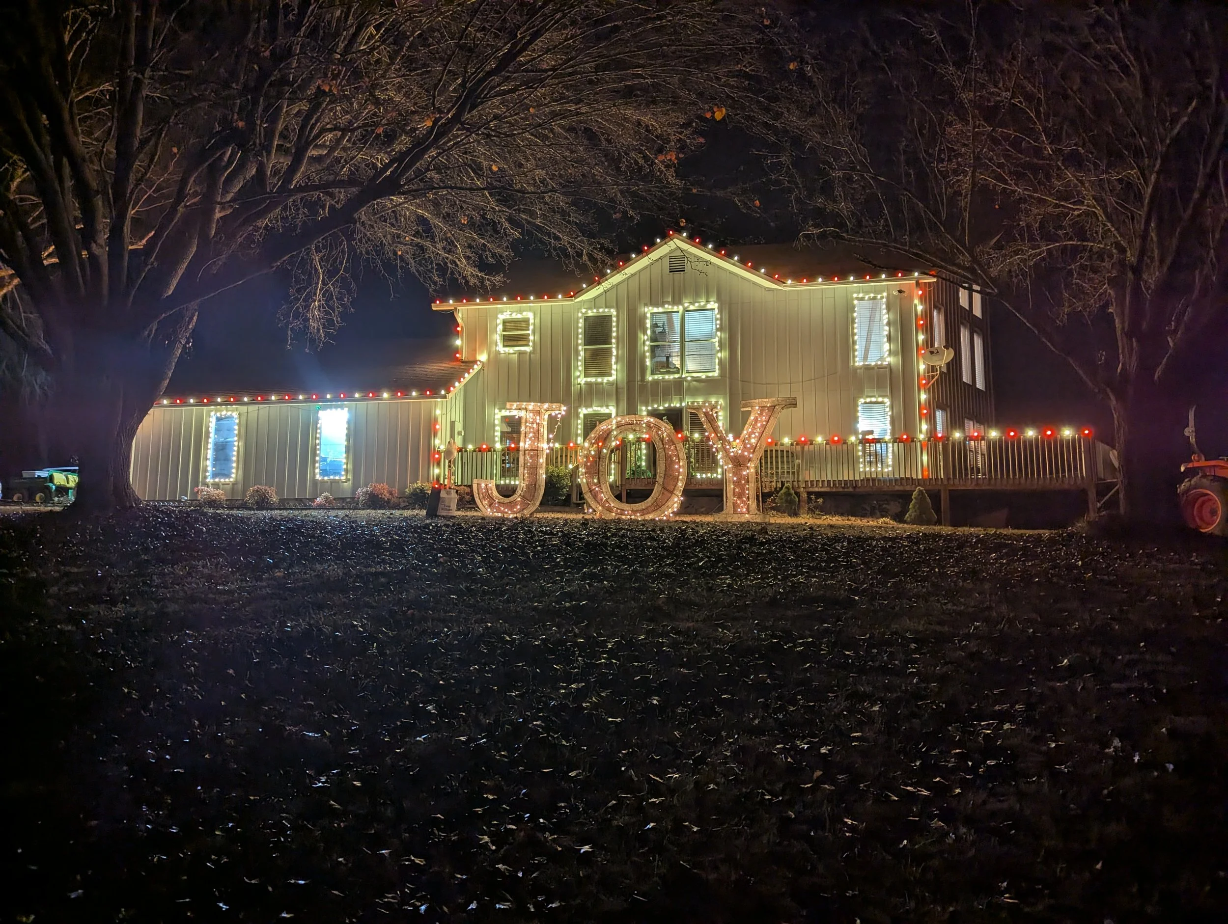 A house decorated with Christmas lights at night, with large illuminated