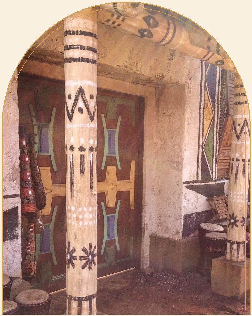 Hand-painted film set column and carved doors in rust red, ochre and teal, aged with grime and wear, Black Panther set in Atlanta