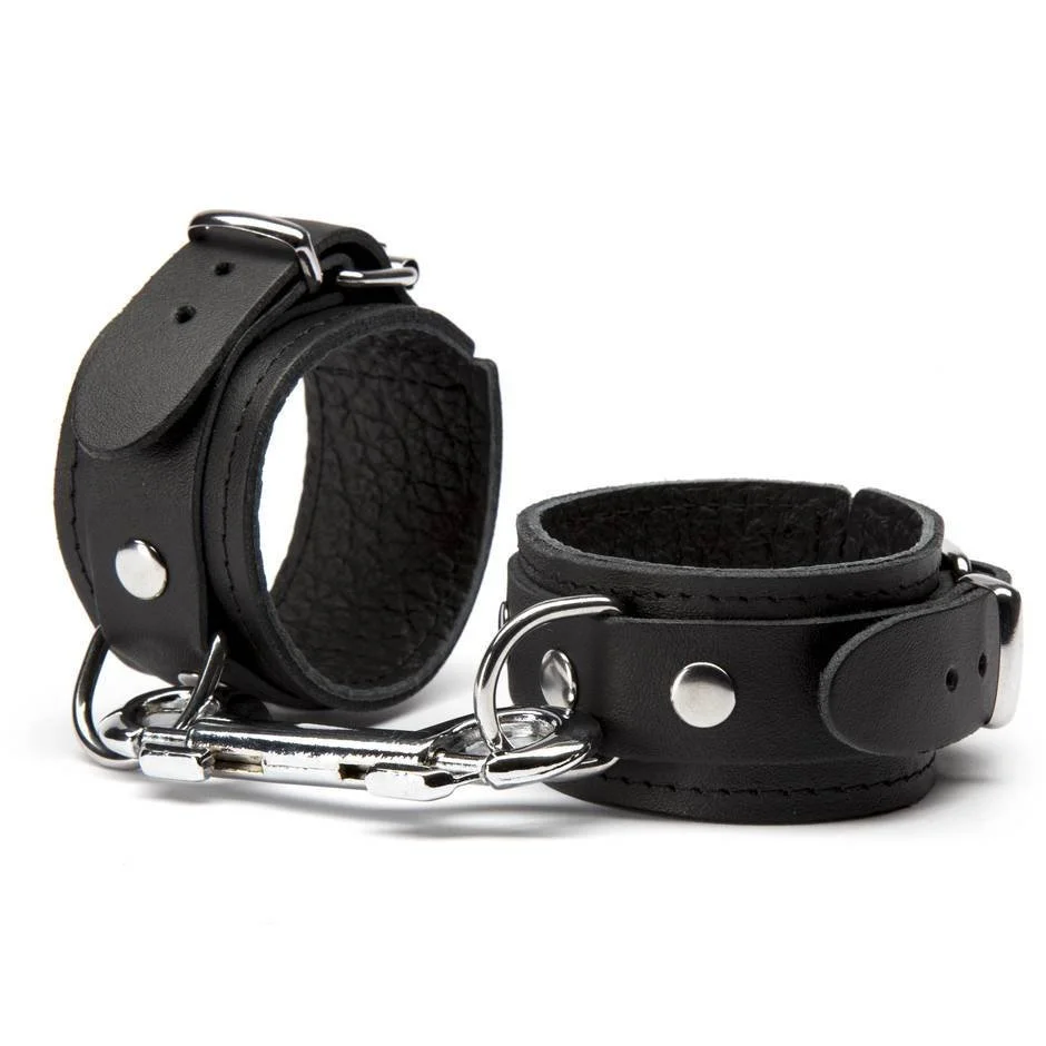 Pair of black leather dog collars with metal hardware and a metal leash clasp.