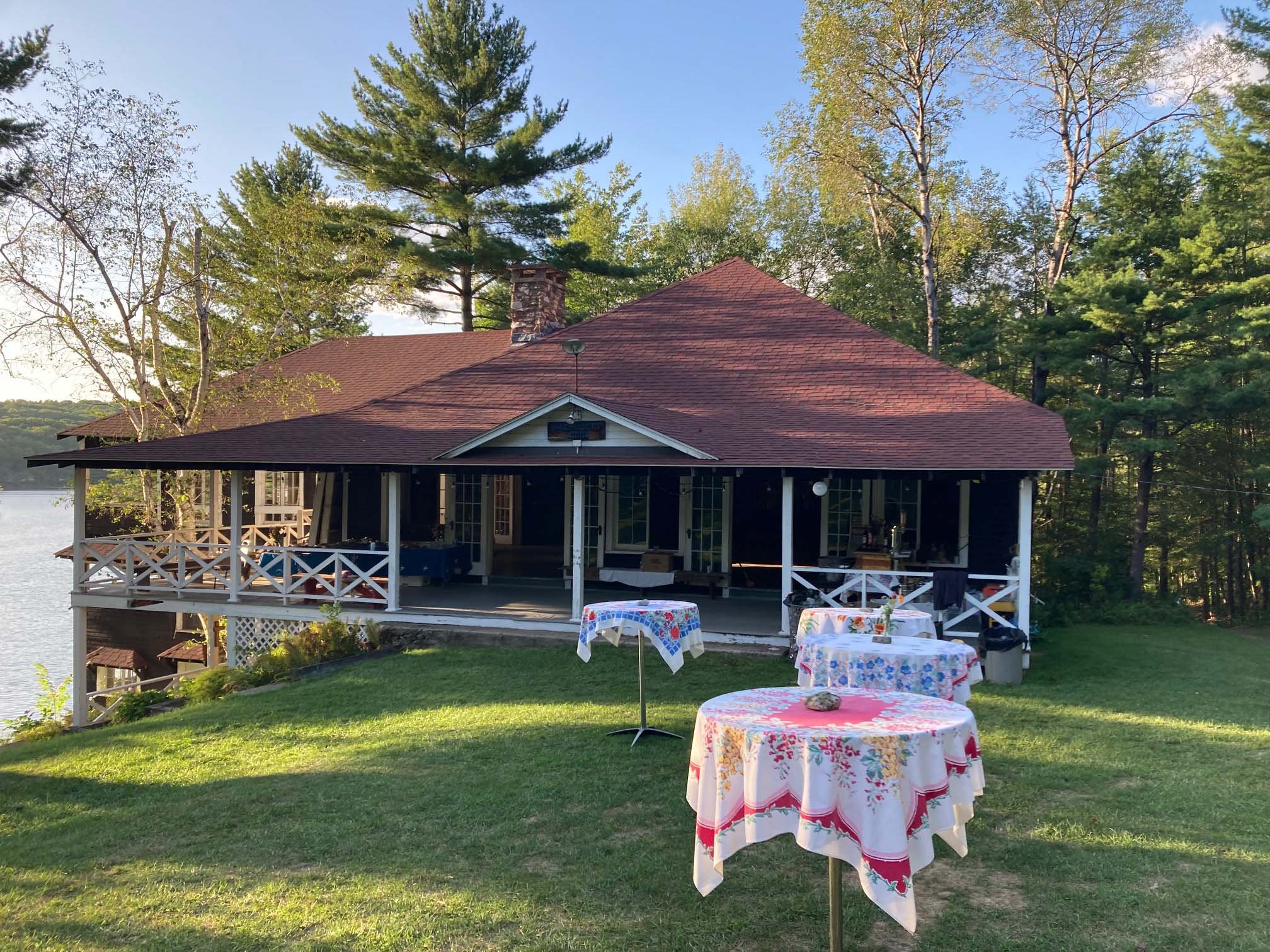 Exterior of the lodge set up for outdoor cocktails during sunset.