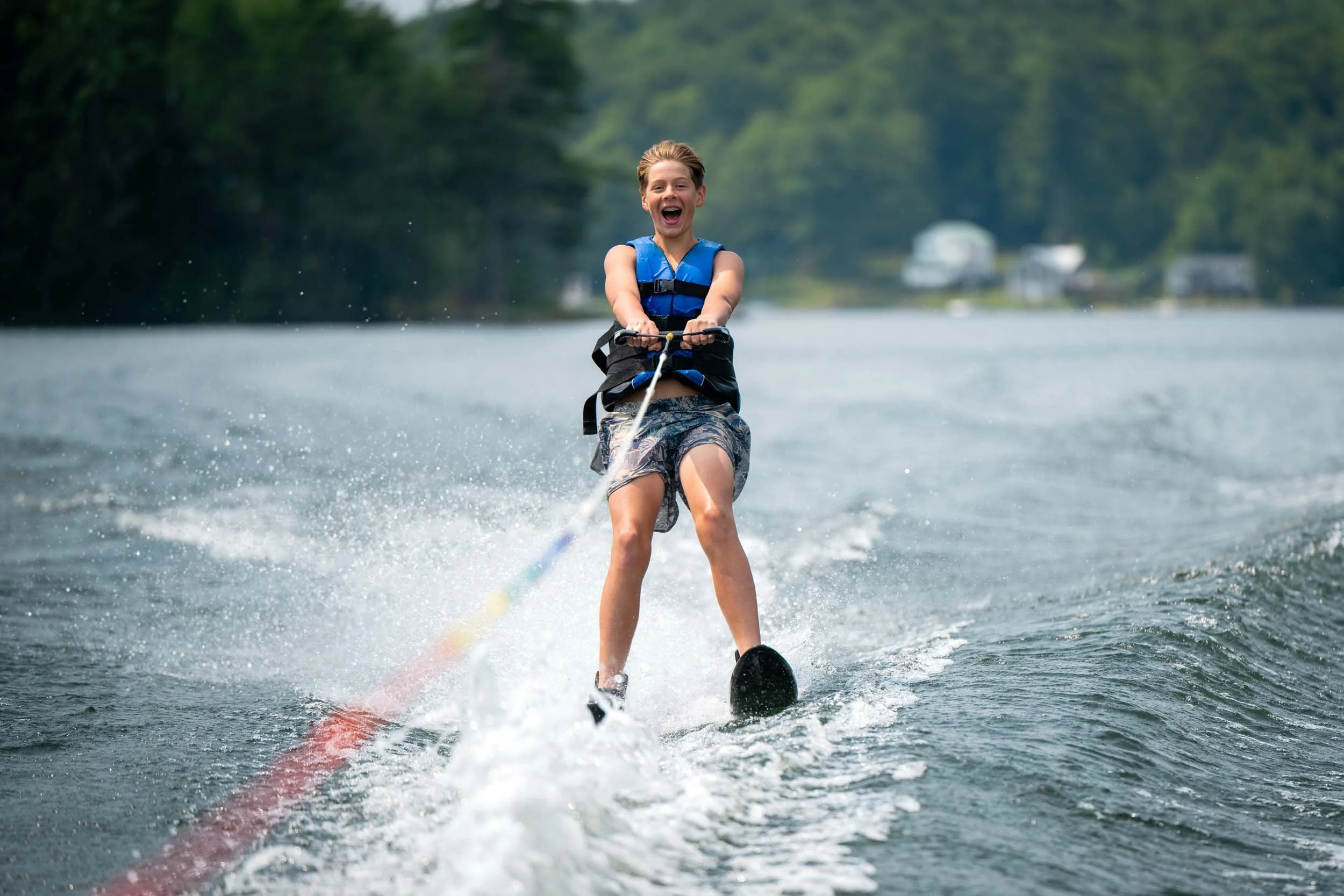 A boy water skiing on a lake.