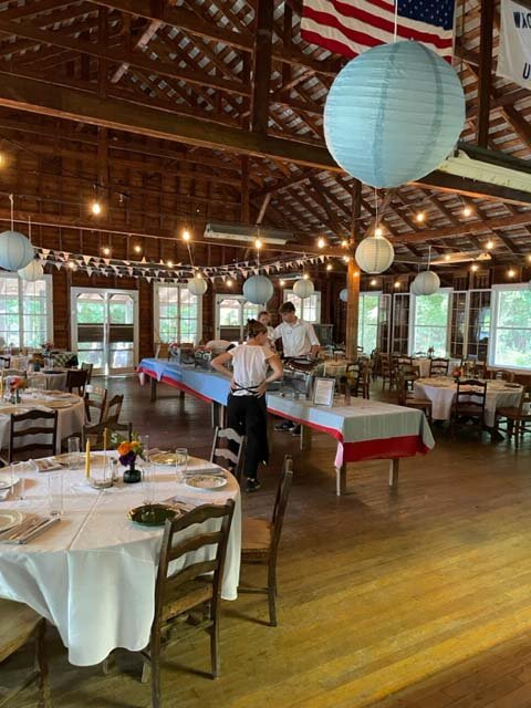 Interior of the wooden dining hall decorated for a wedding reception.