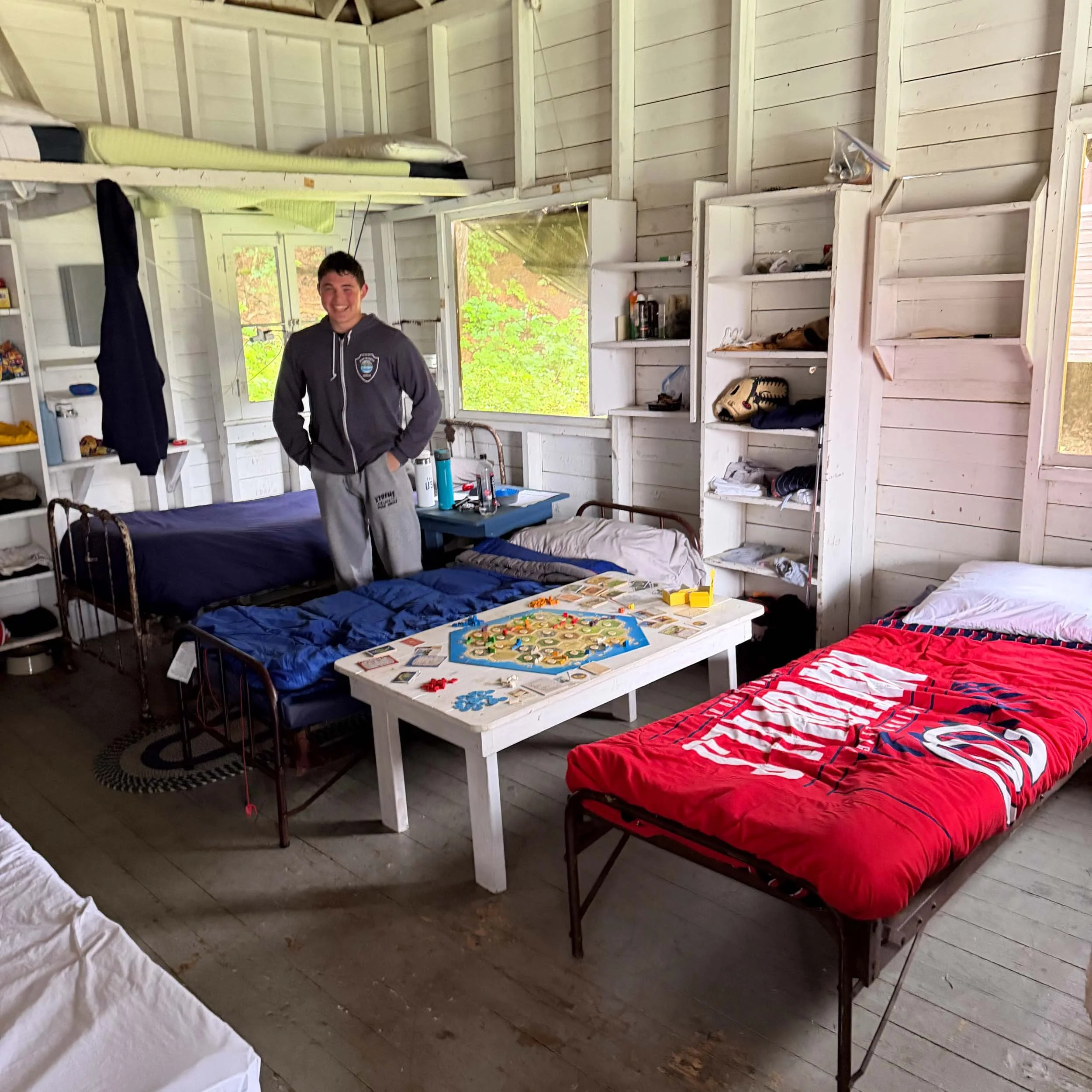 A camper standing in a bright, spacious cabin after cabin cleanup.