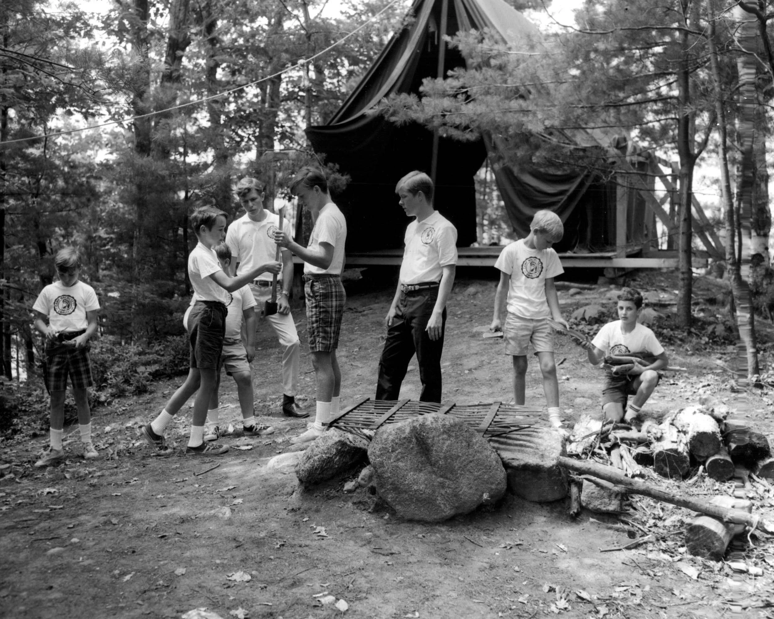 Vintage photo of boys setting up a campsite.