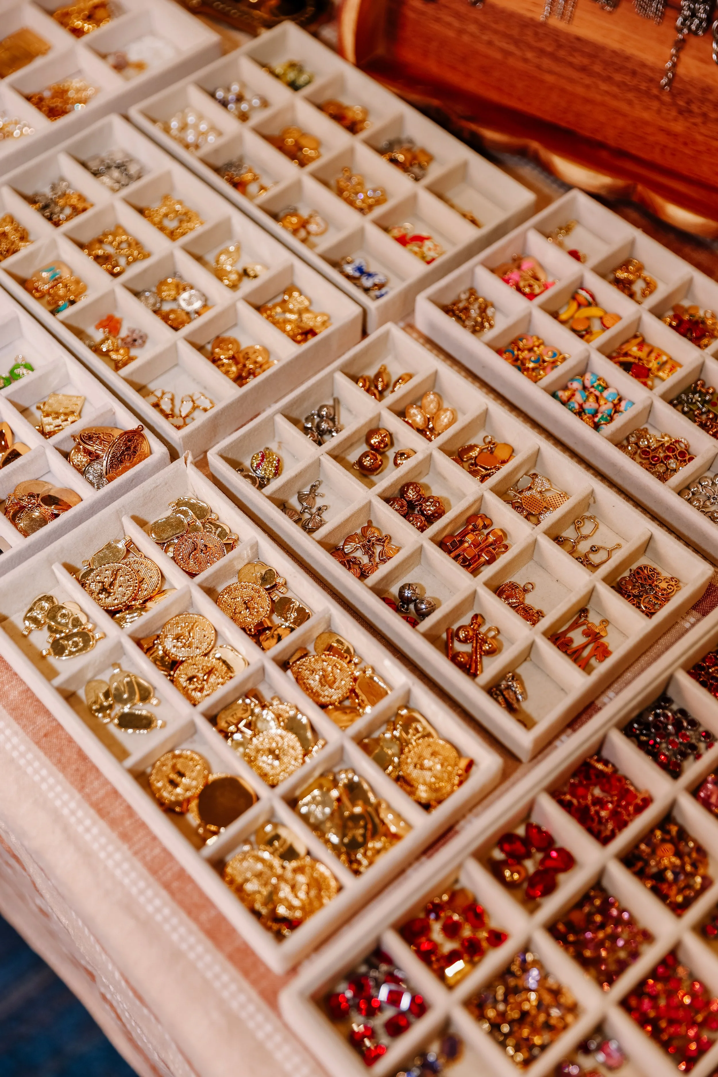A display case filled with various gold, silver, and colored costume jewelry and accessories.