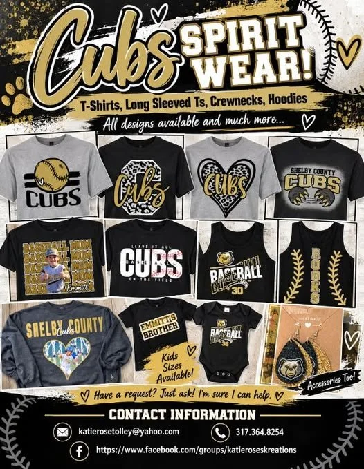 A promotional display for Shelby County CUBS spirit wear, showcasing various T-shirts, long-sleeve shirts, crewnecks, and hoodies with baseball-themed designs and local references.