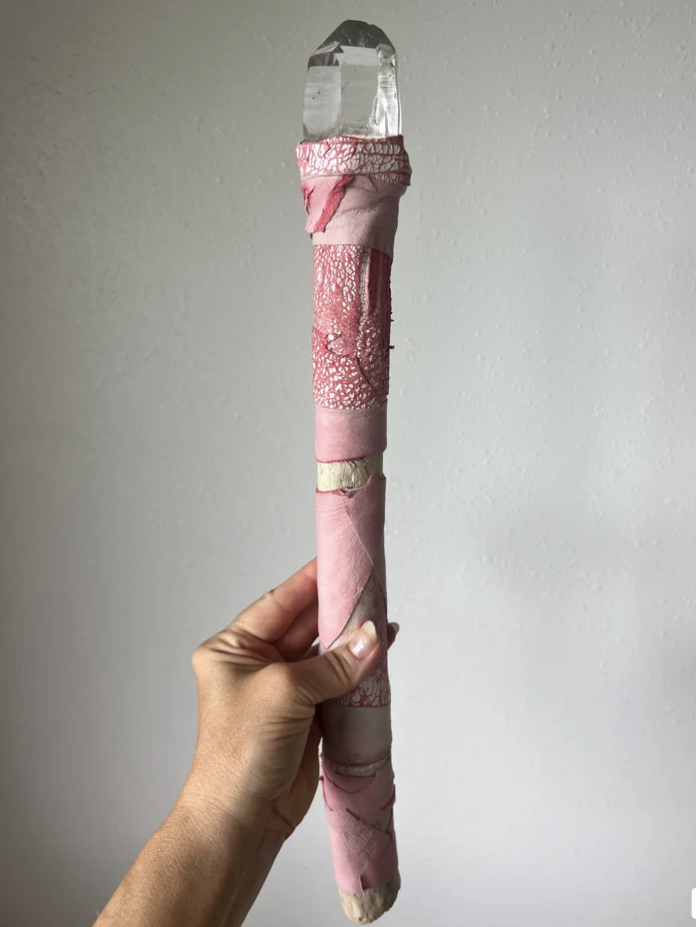 This crystal screams "QUEEN!" A stunning Colombian Lemurian quartz with a diamond window. Distressed and painted Italian leather in pink and tie-dye pinks adorns this wand. This one has some weight to it.

Wand is 19" in length and wrapped in beautif