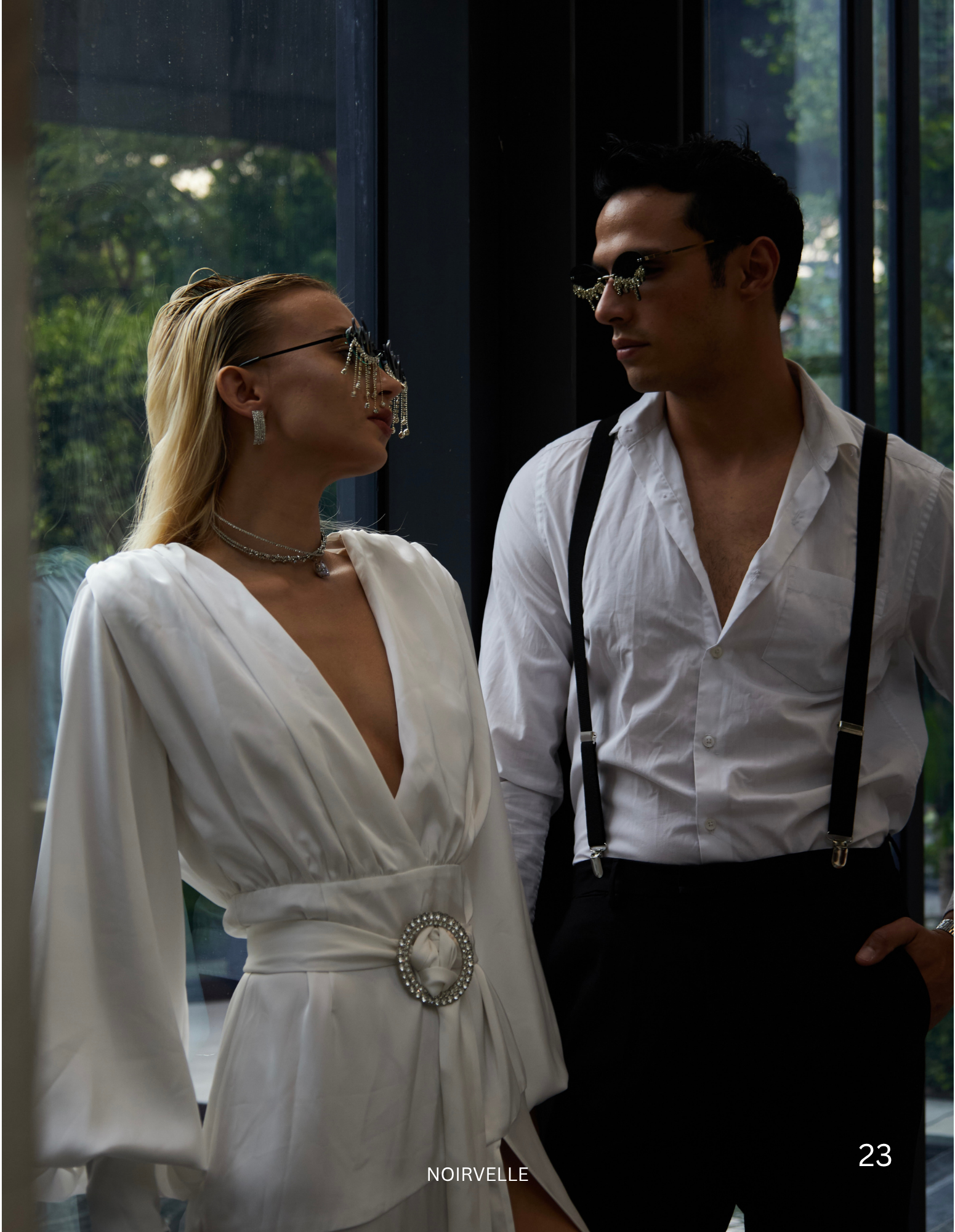 Fashion editorial featuring a male and female model in elegant black-and-white styling, photographed by Noirvellel.