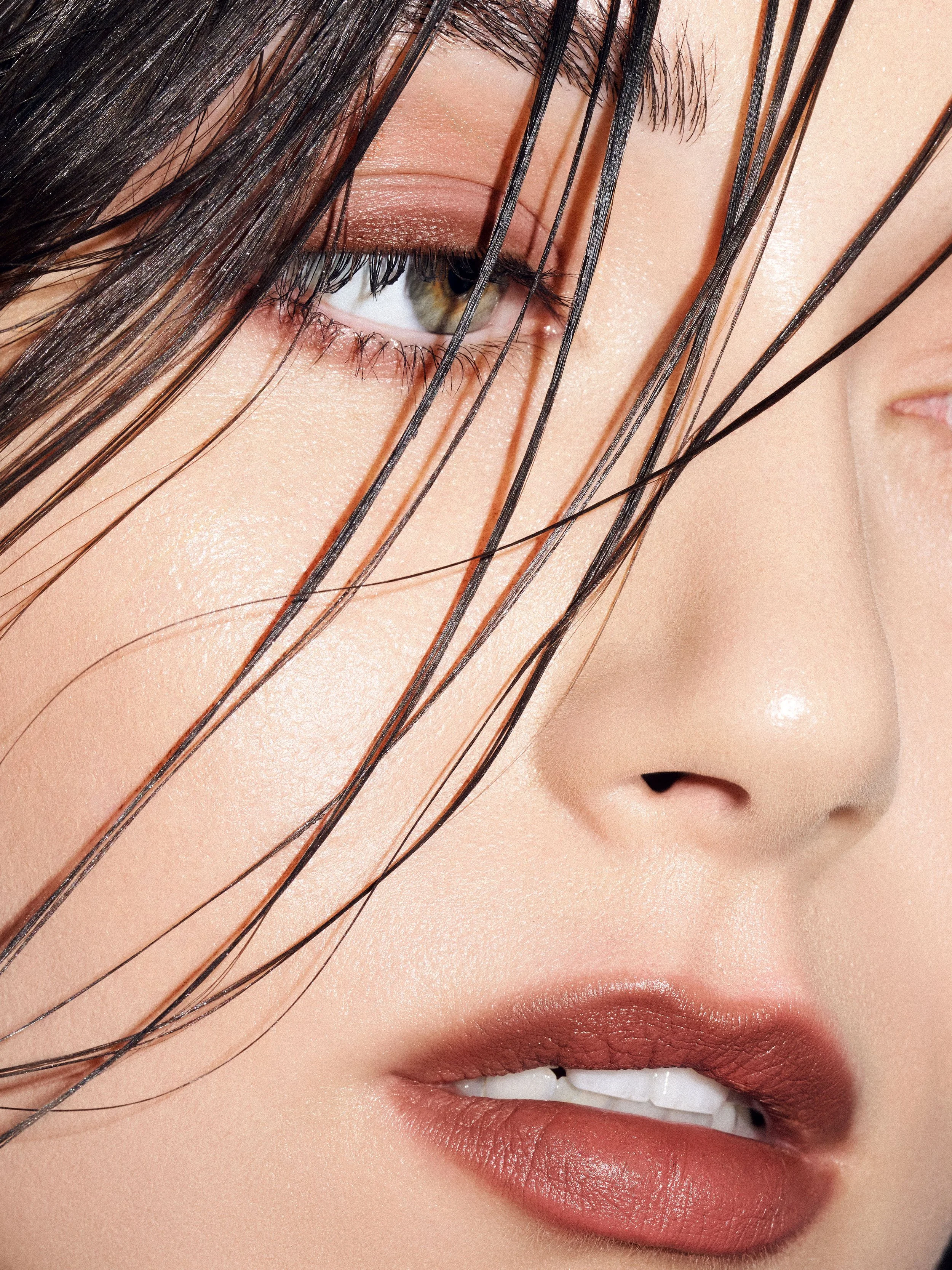 Close-up beauty portrait of Noirvellel, model and fashion photographer, with wet hair and natural skin texture.