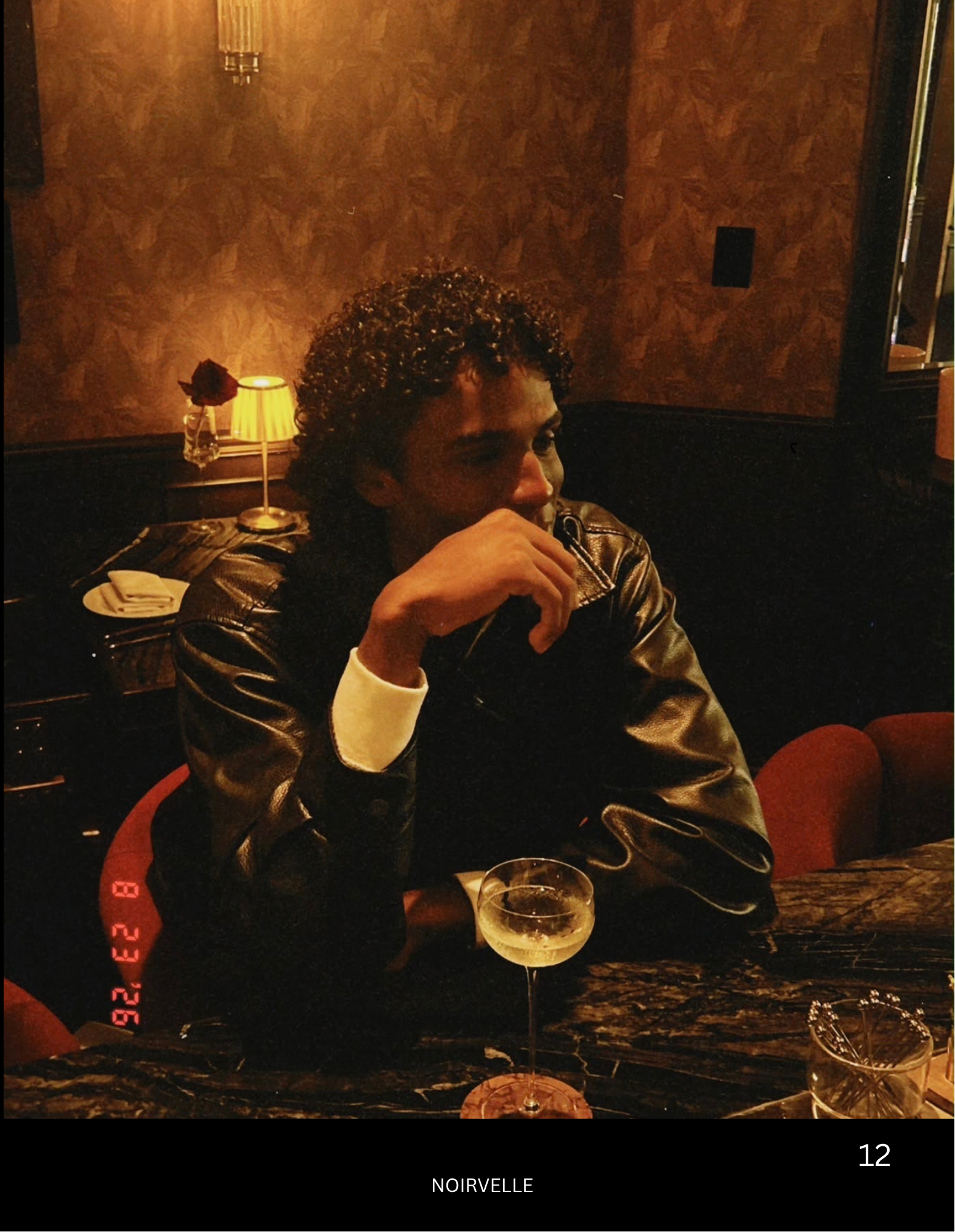 Lifestyle editorial portrait of male model in a dimly lit restaurant – Noirvellel
