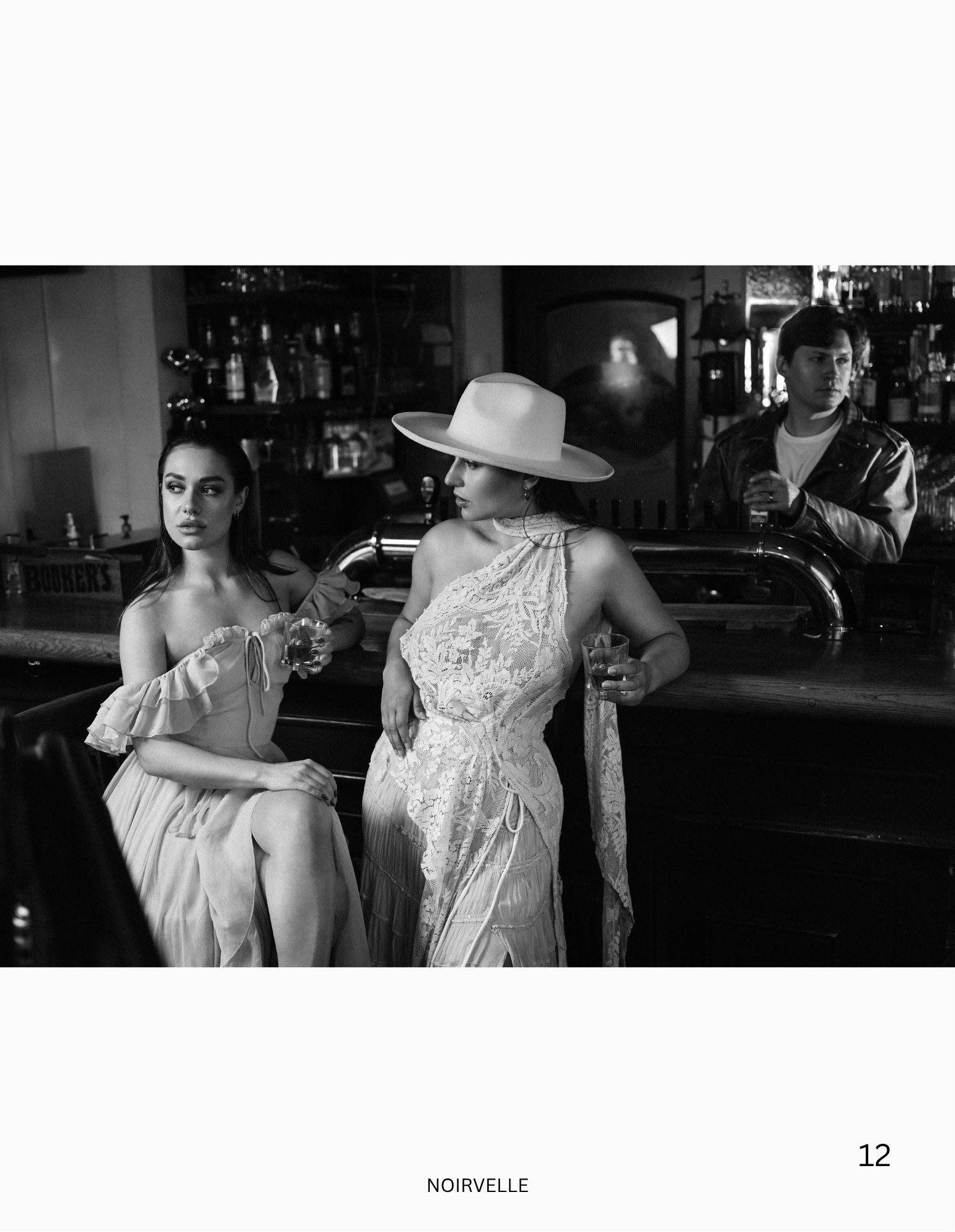 Black-and-white fashion editorial featuring three female models in a vintage bar setting.

