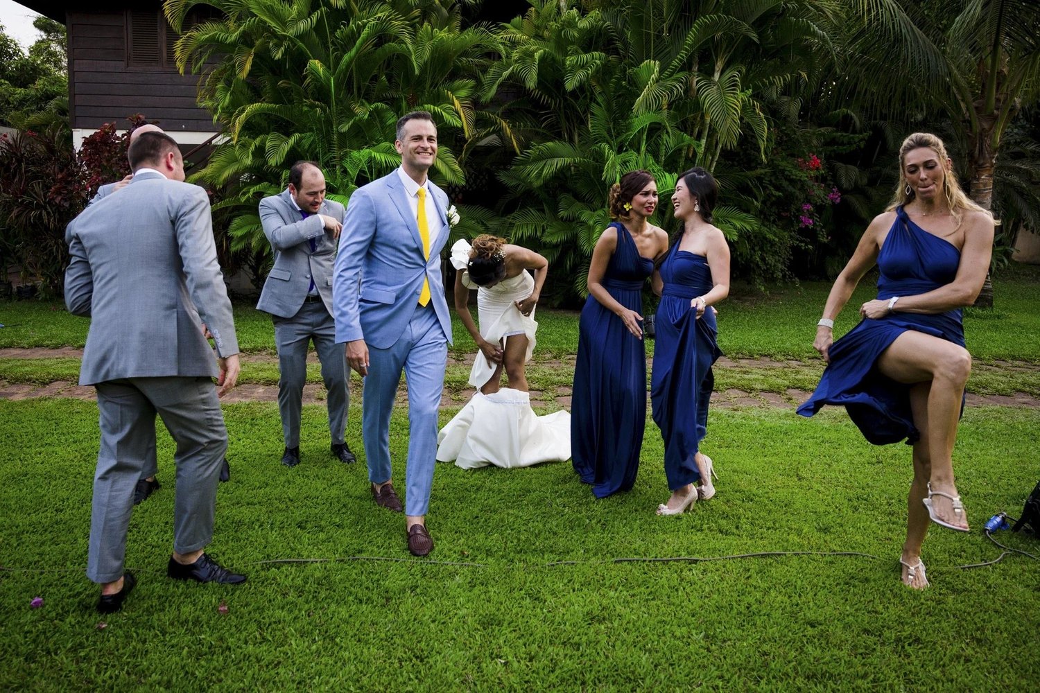 Wedding party moving together across a lawn at Adam and Celeste’s wedding.