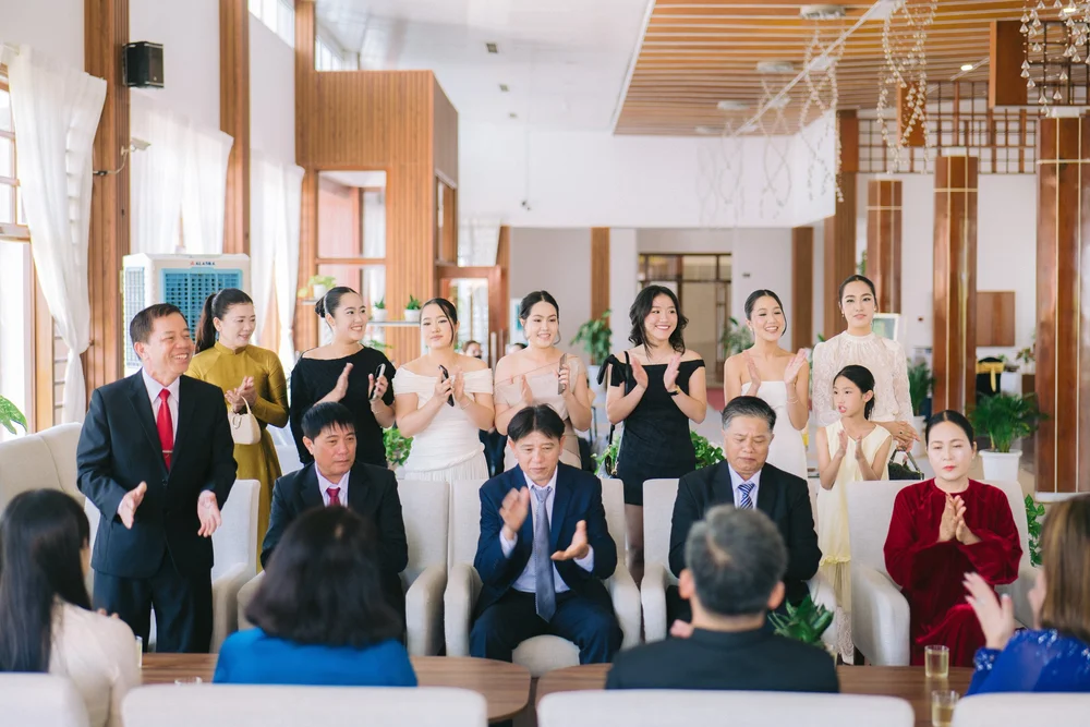 People smiling and clapping in the gathering
