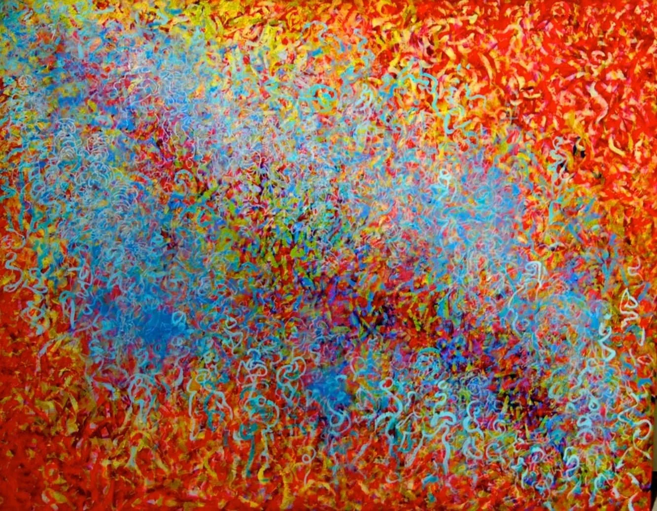 Colorful confetti and curly paper strips in red, blue, yellow, and white scattered all over a surface.