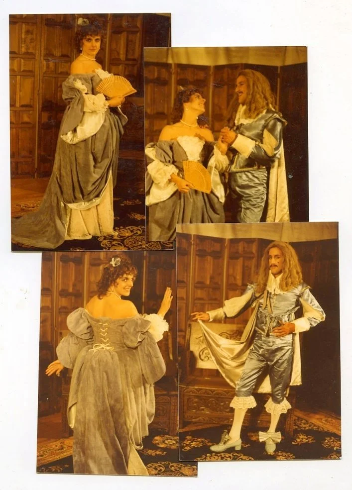 Photographs of two actors in elaborate 17th-century costumes performing on stage in a wood-paneled room.