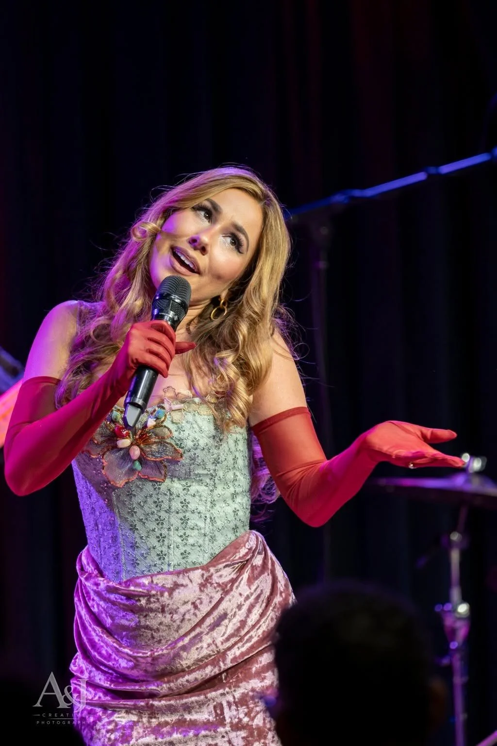 Reinhart gestures toward the room during her Middle C Jazz appearance.