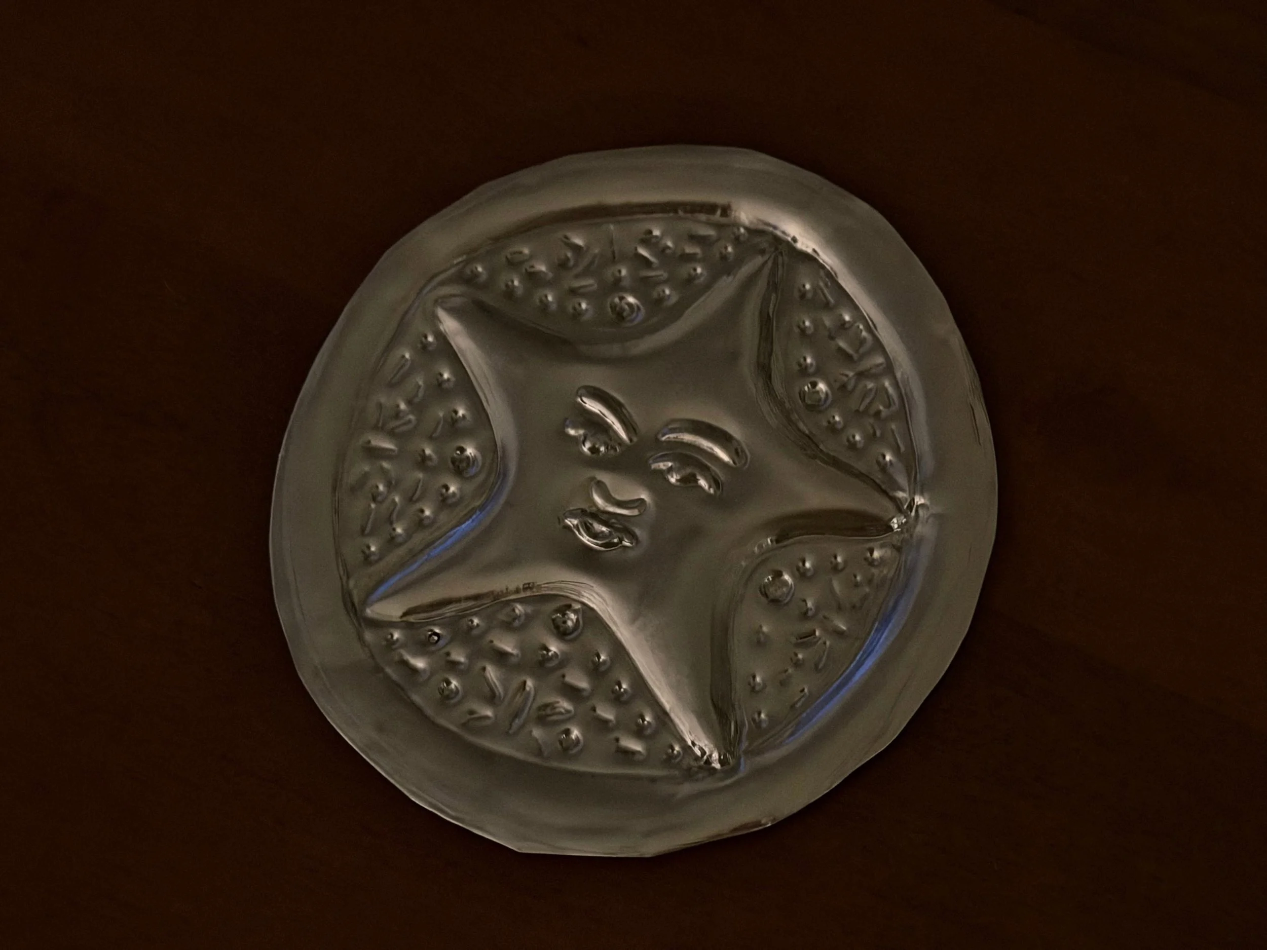 Hand-embossed metal with intricate raised star detailing