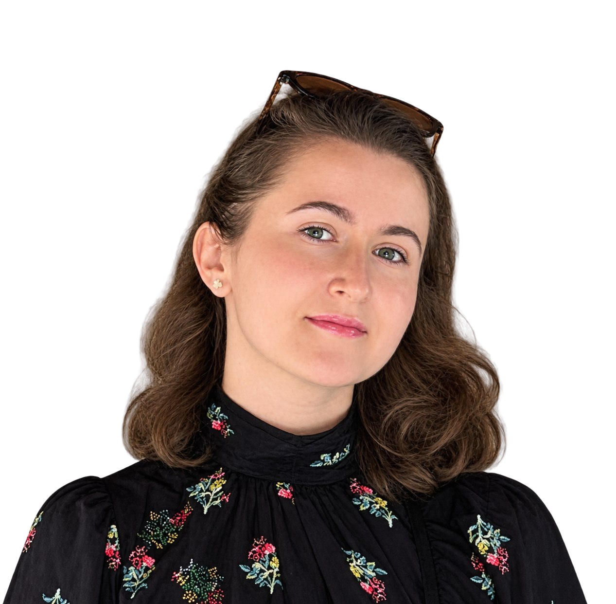 Portrait of a young woman with brown hair, blue eyes, and light skin.