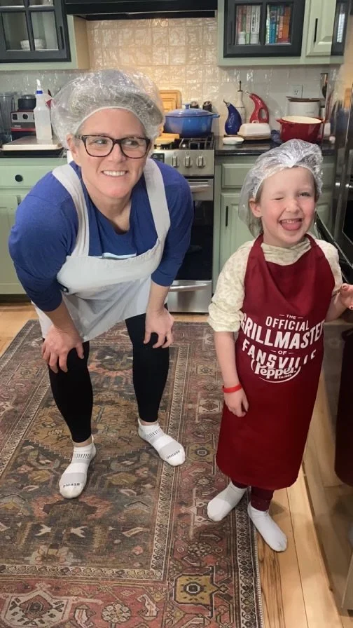 Chris with her granddaughter helping in her home kitchen