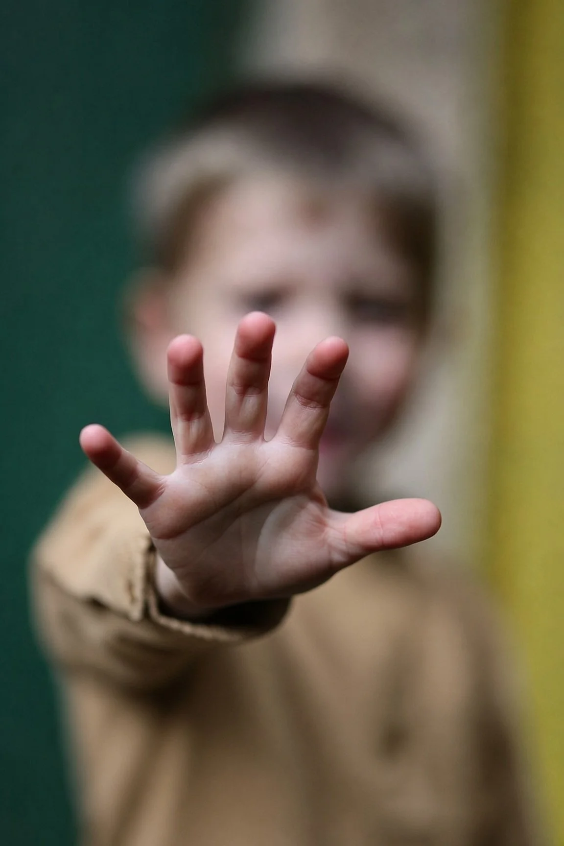 Young child reaching out a hand