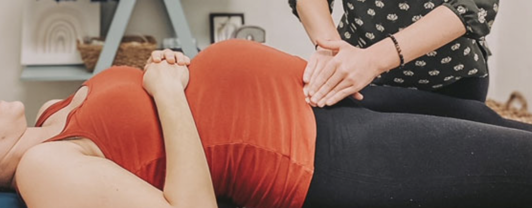 Pregnant person laying face up having their round ligaments massaged by chiropractor using Webster Technique. Helps with pregnancy pains, back pain, pelvic pain, symphysis pubis dysfunction, tailbone pain, leg thigh pain, prepare body for labour