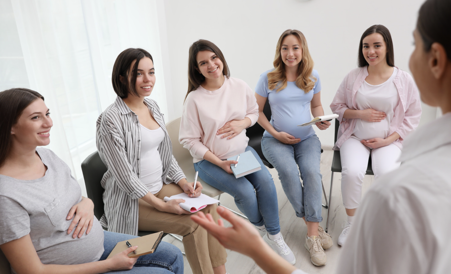Group of women sitting in a row during a prenatal education class