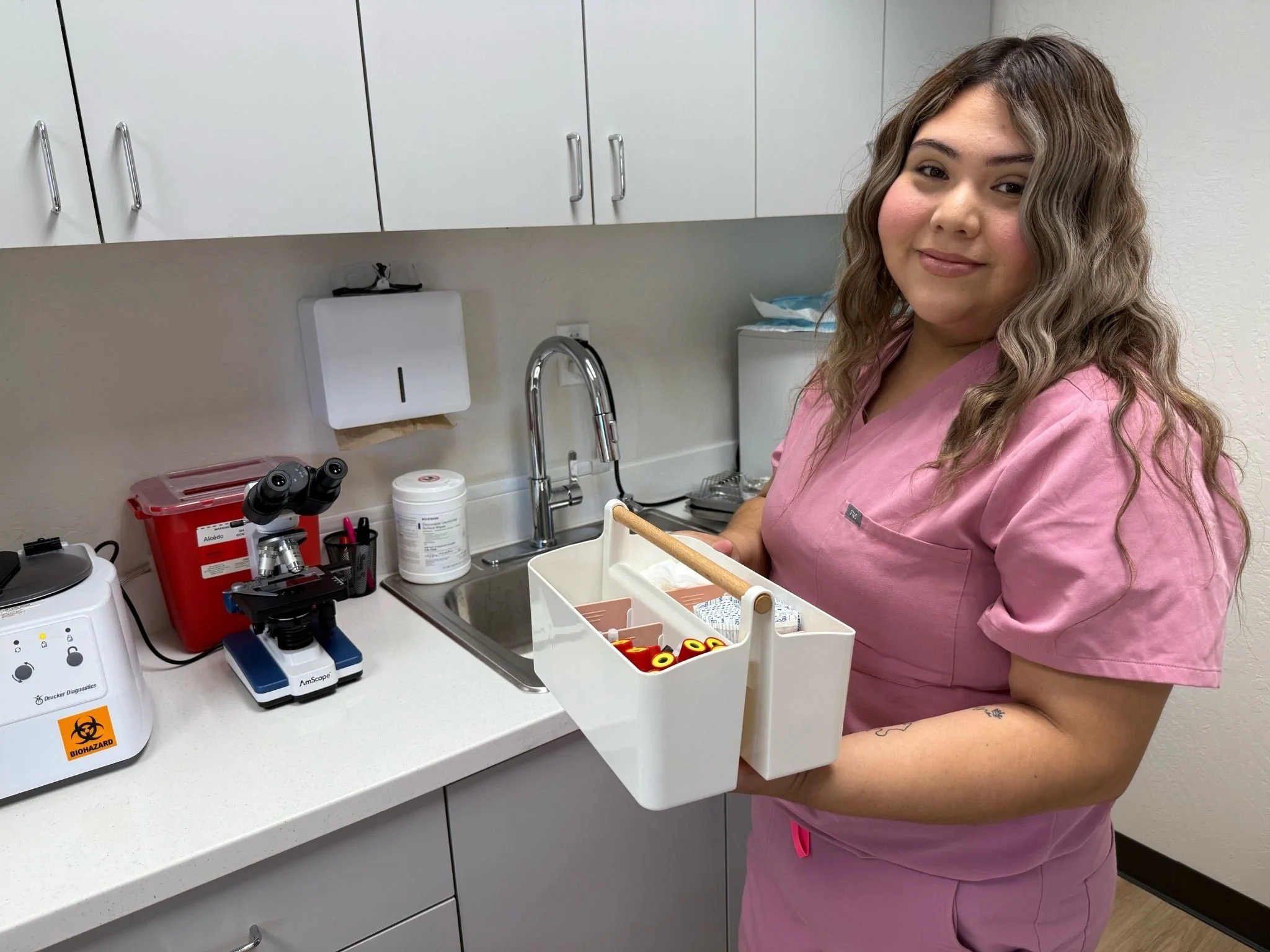 Karla Juarez - Medical Assistant at quick gyno, holding a blood vials in the lab.